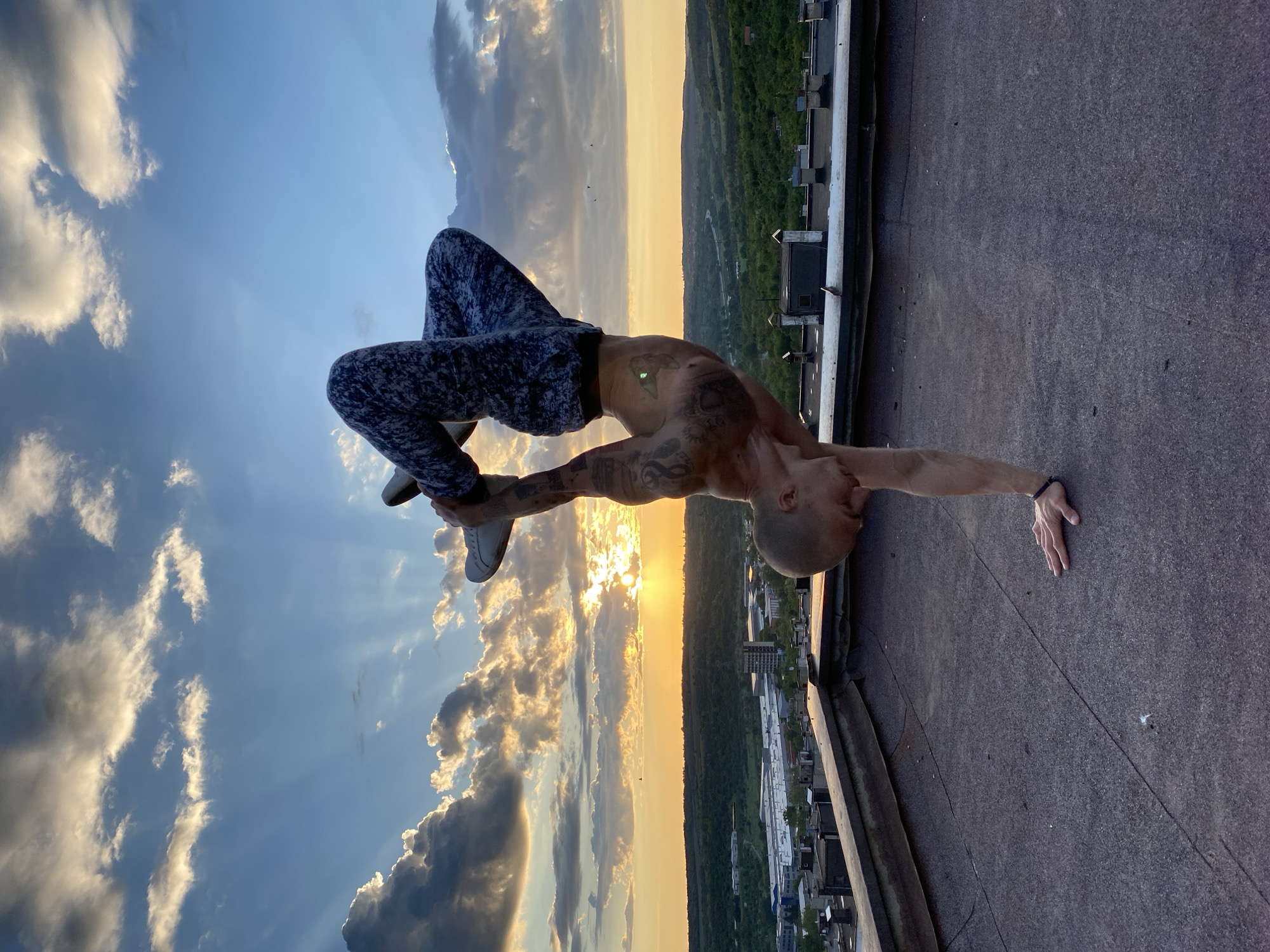 Man performs rooftop handstands during sunset in Pleven, Bulgaria