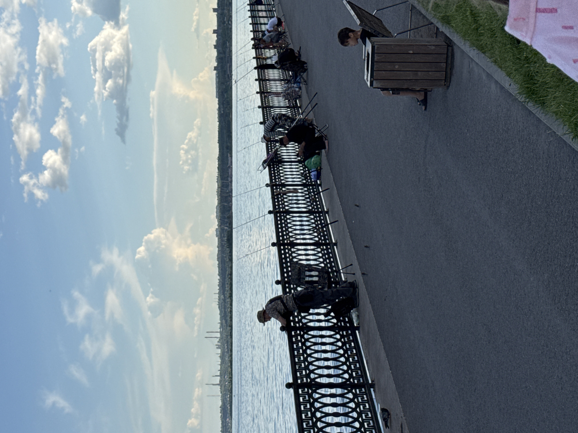 Waterfront promenade bustles with families, performers, boaters during afternoon