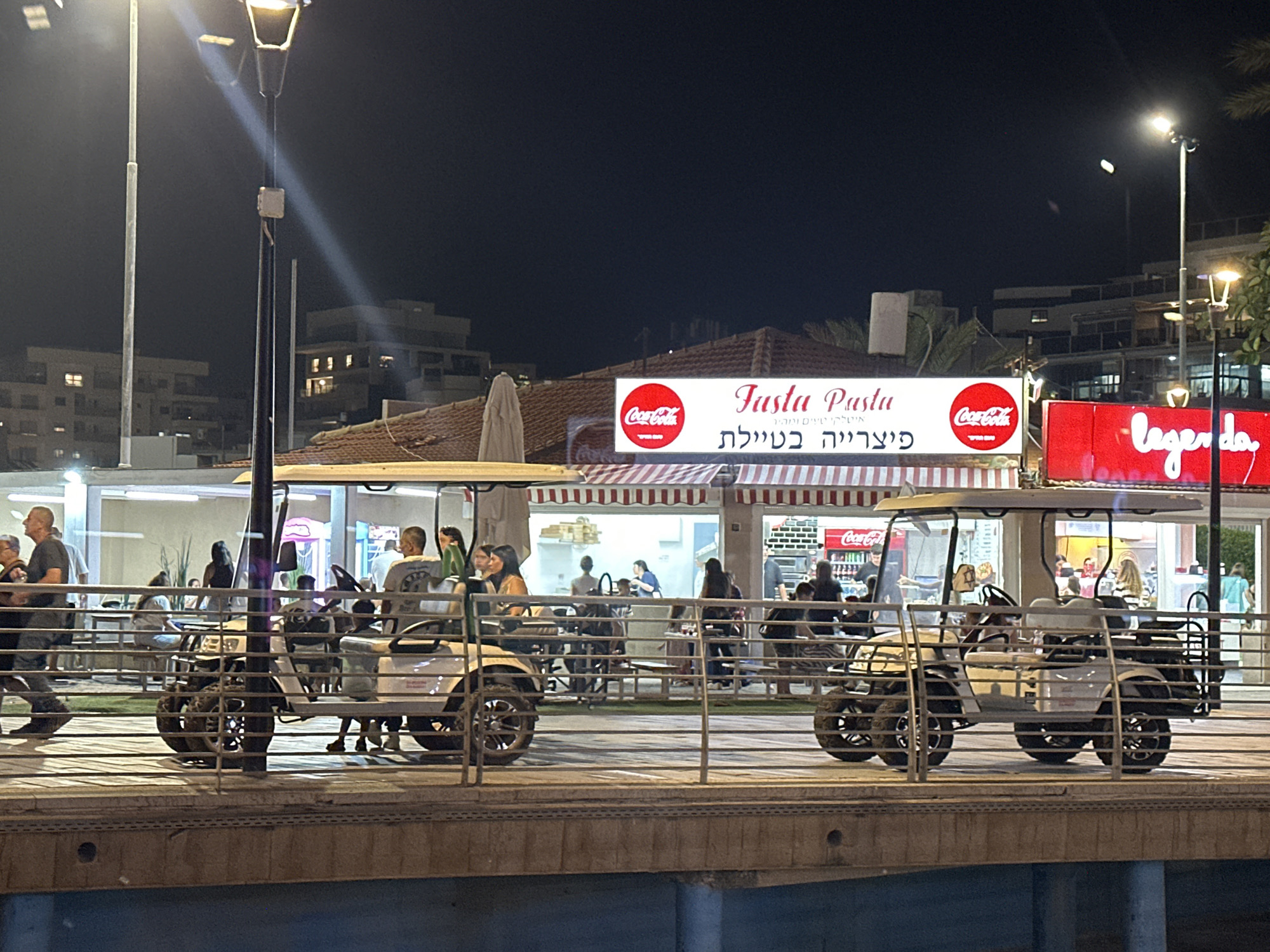 Nahariyya's beachfront promenade lit up on a summer night