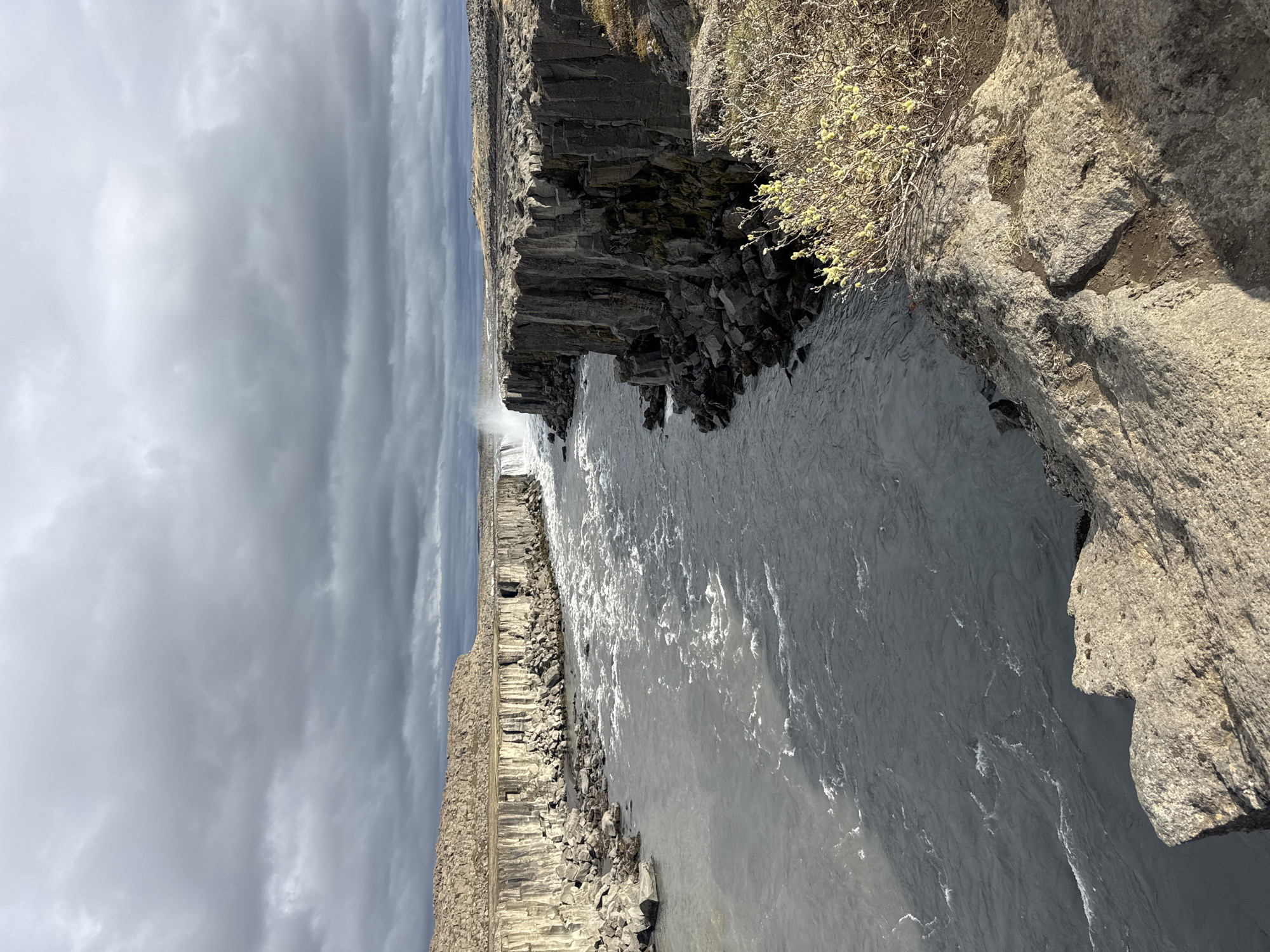 Tourist documents Icelandic waterfall and canyon river system