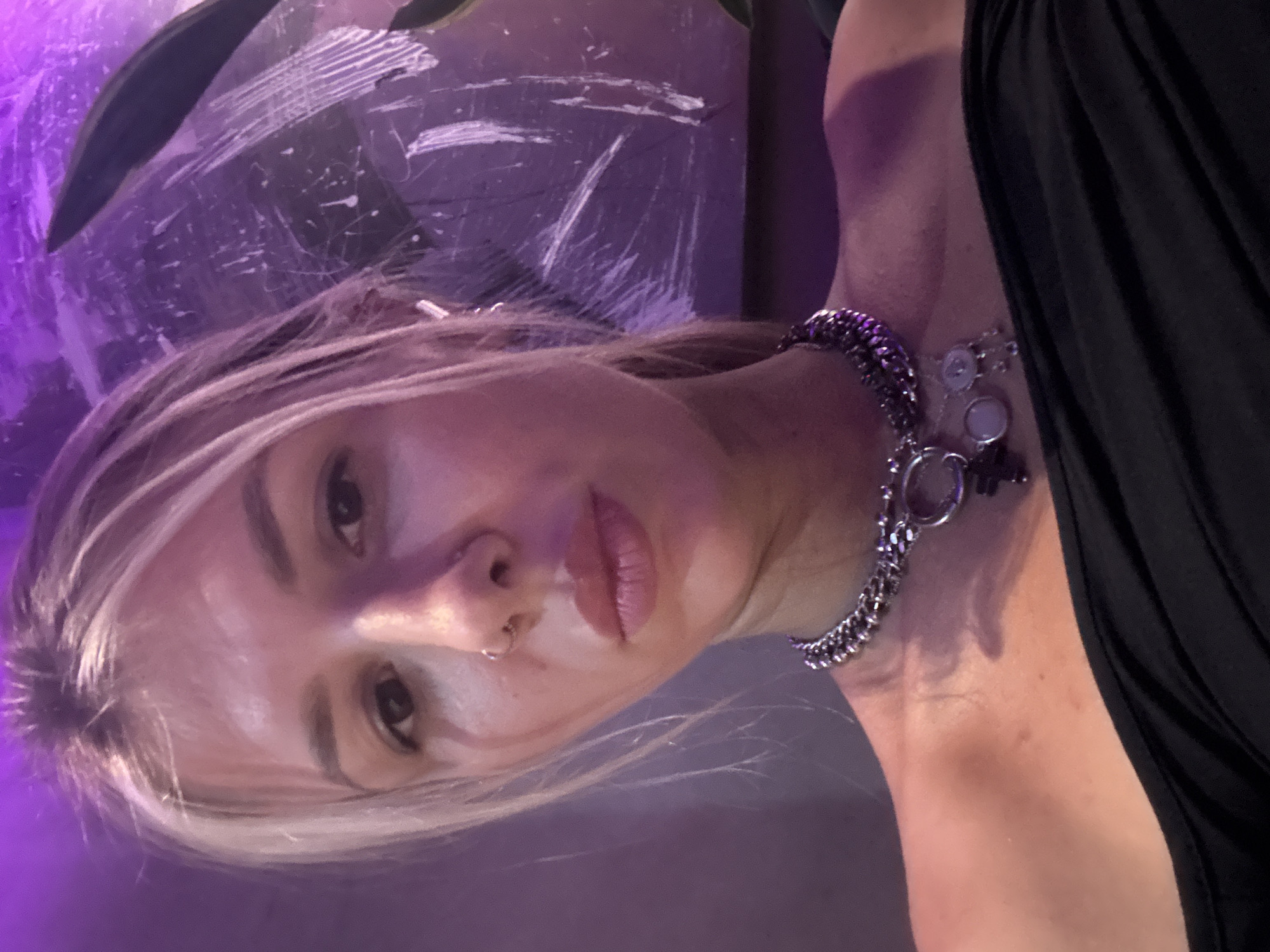 Multiple selfies in a moody, purple-lit indoor setting