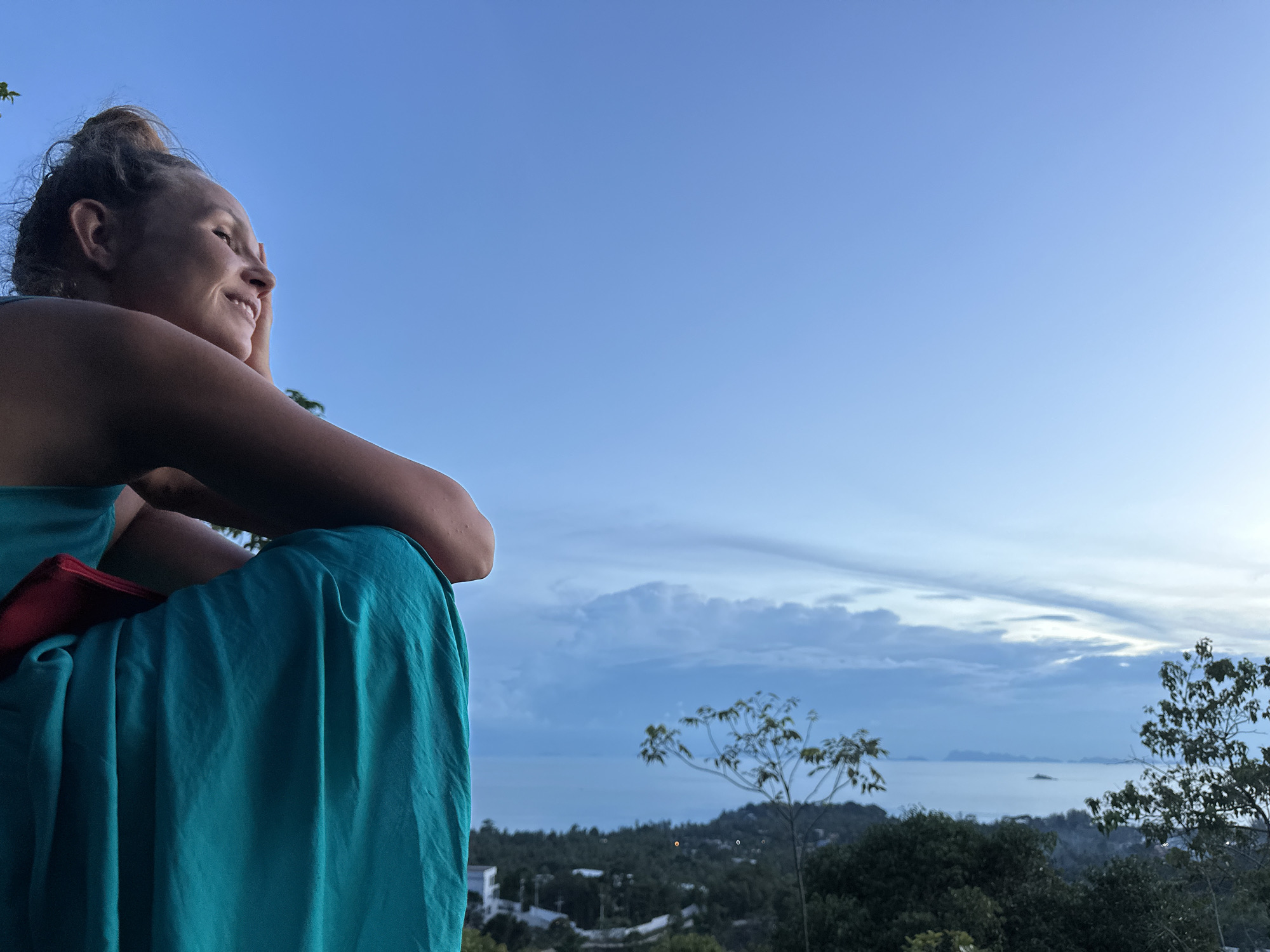Sitting on the rocks above Koh Phangan's ocean panorama