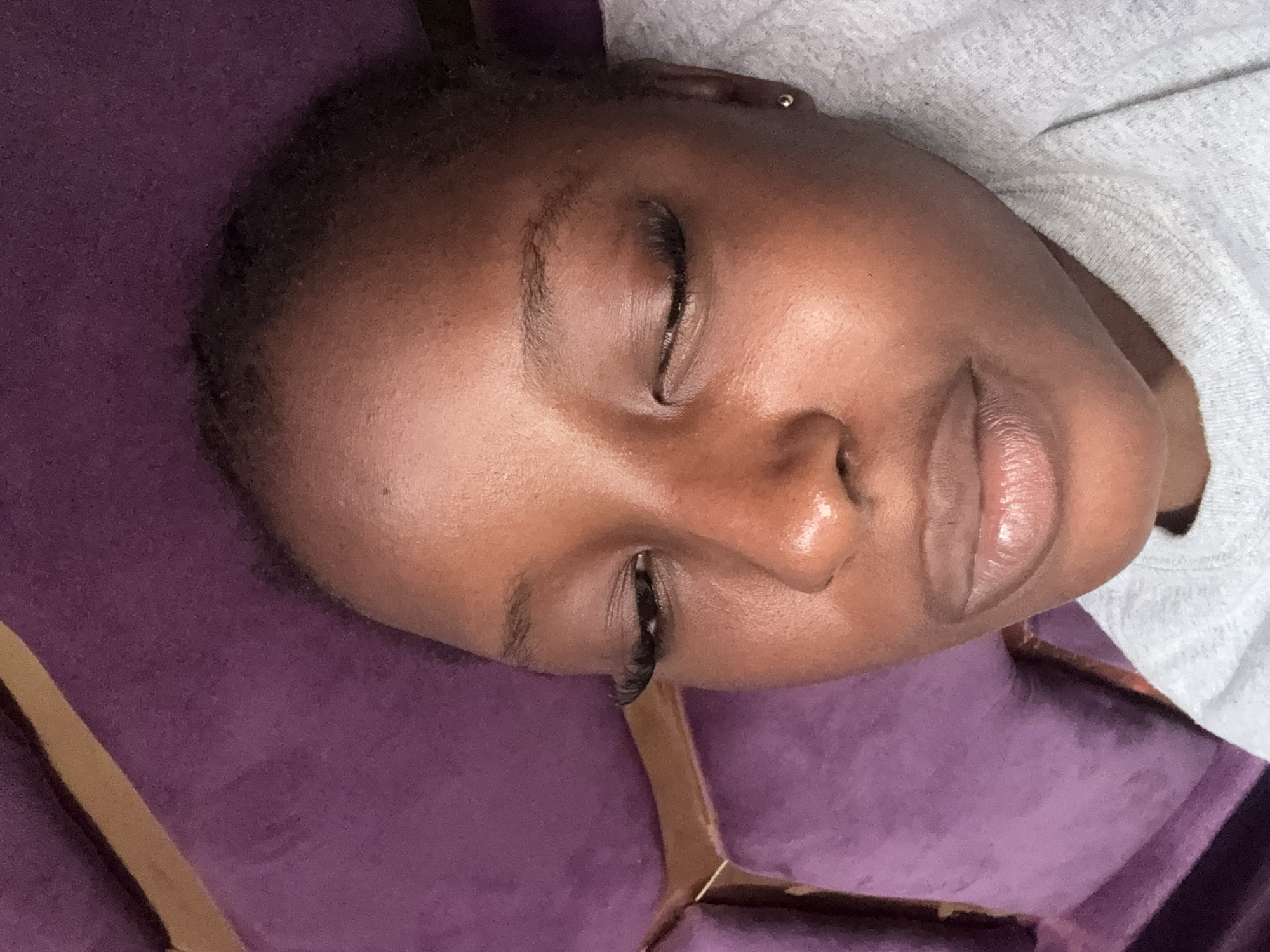 Woman photographed relaxing on purple furniture in Nigeria