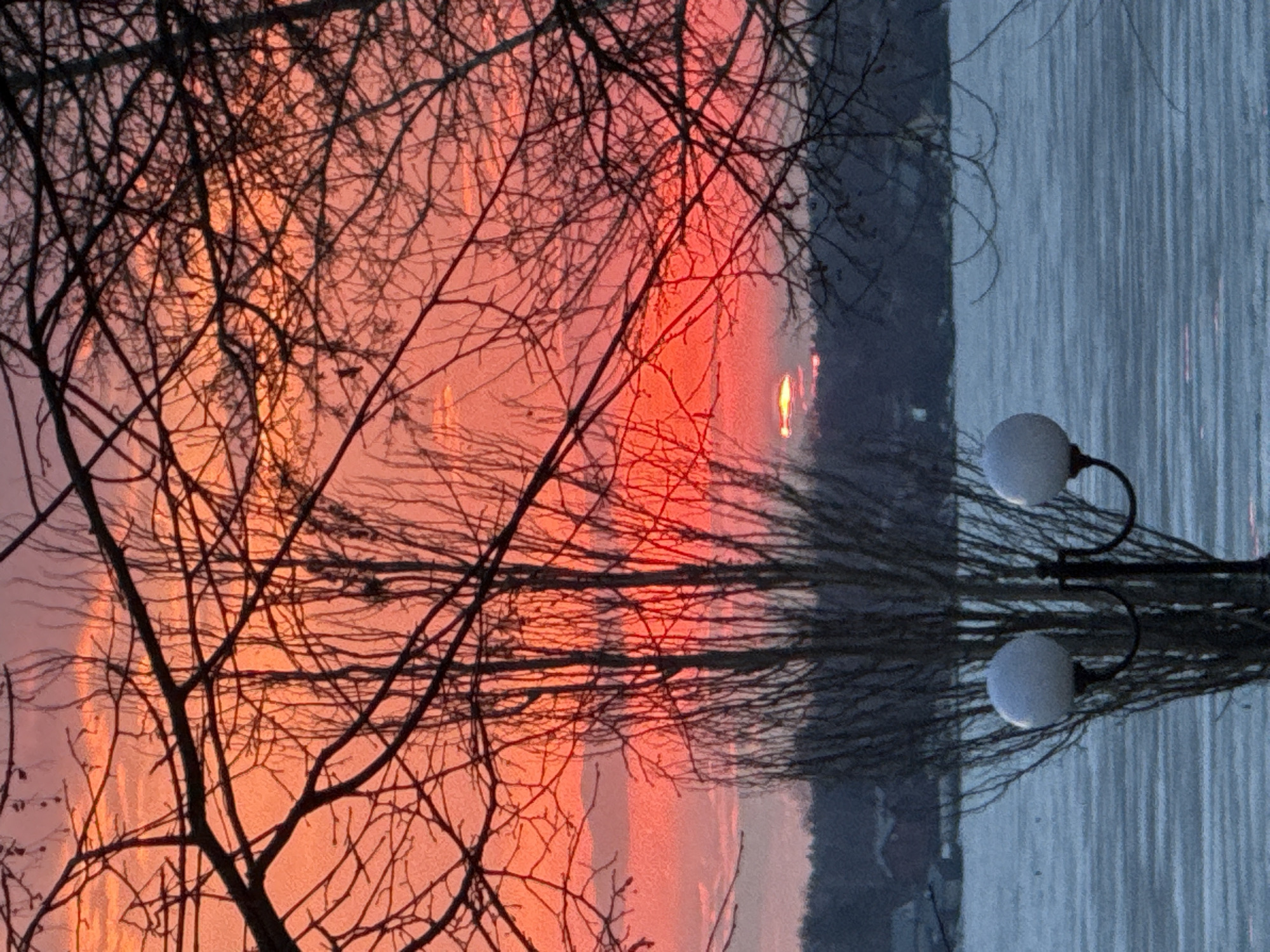Dramatic sunset captured along Votkinsk waterfront with scooter rider