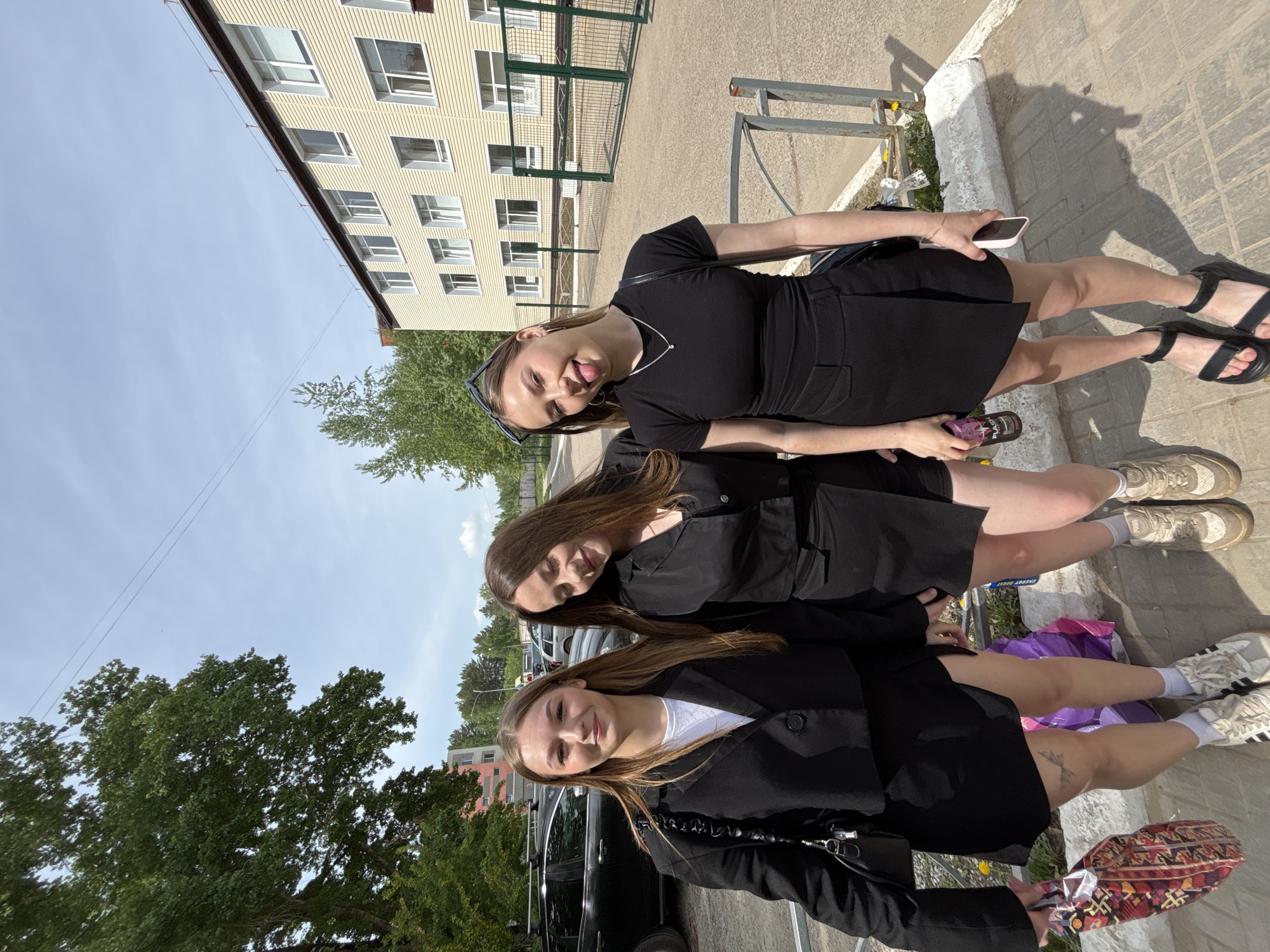 Young women gather for photos on Chaikovsky sidewalk