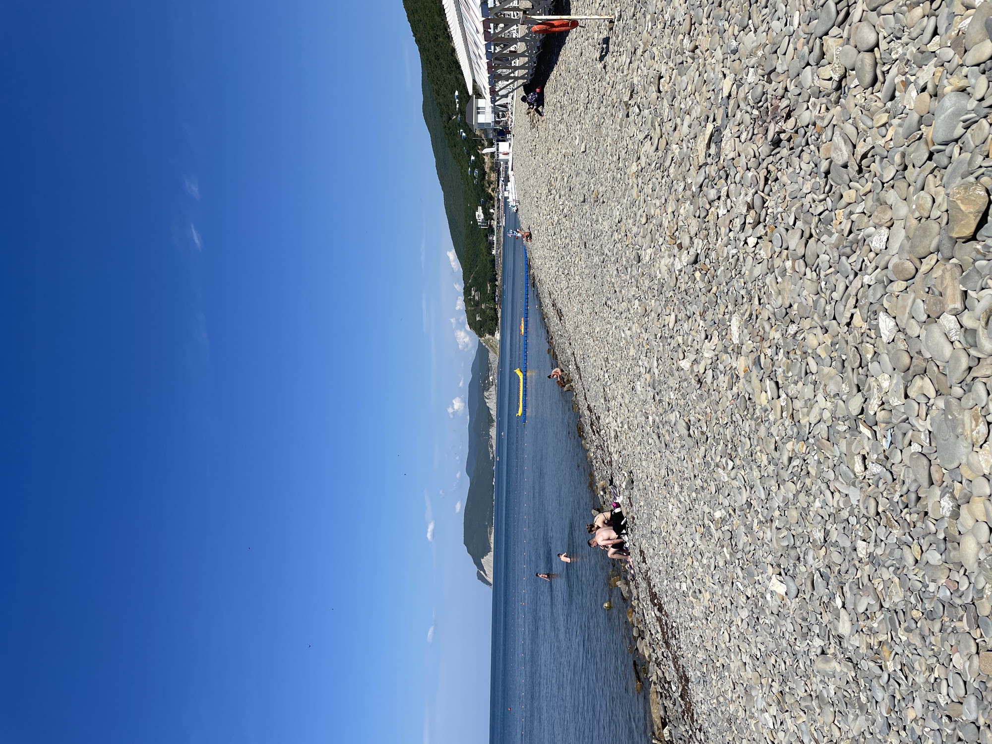 Calm summer morning at Shirokaya Balka's Black Sea pebble beach