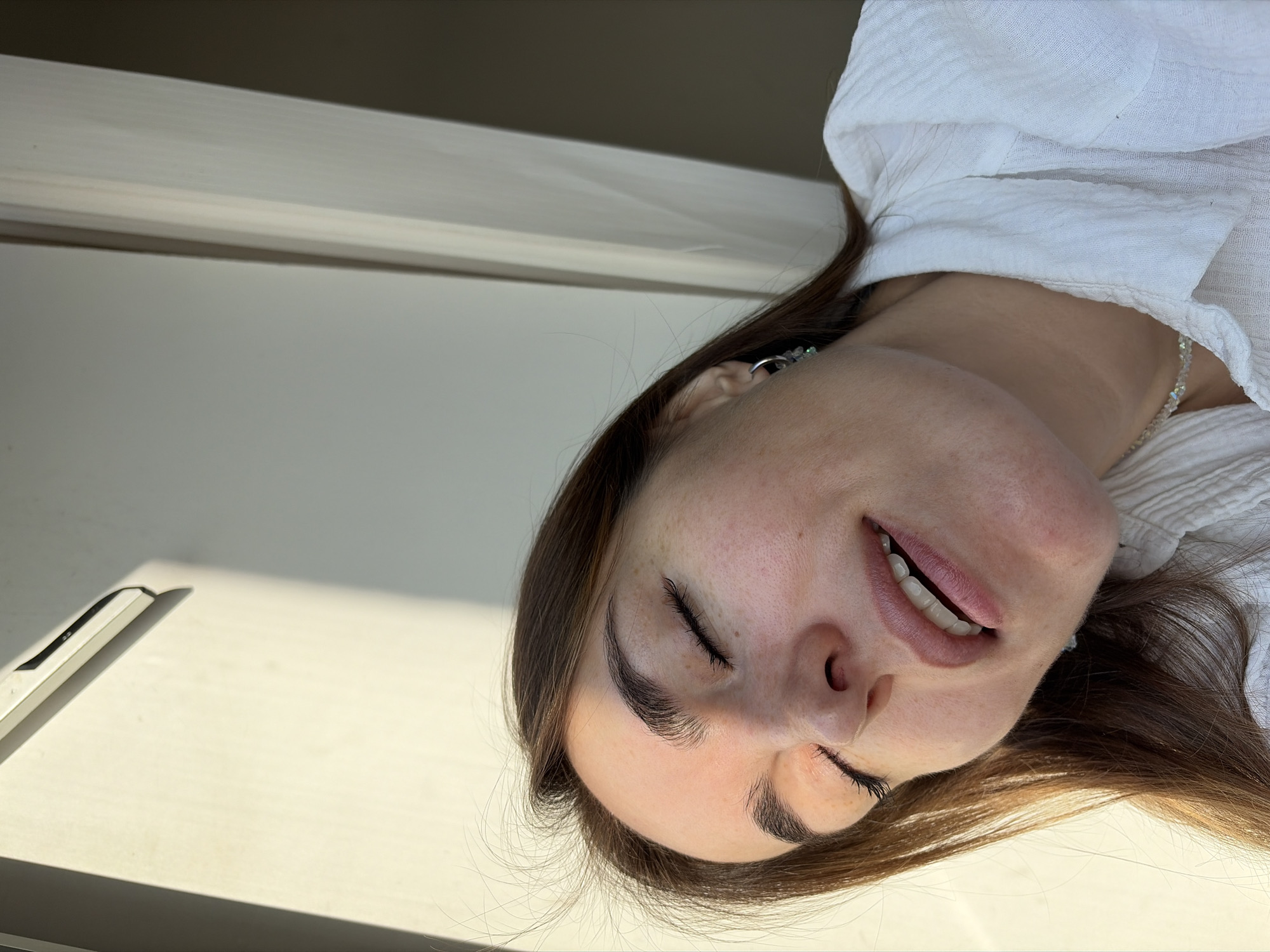 Woman photographed in multiple poses near window in Izhevsk