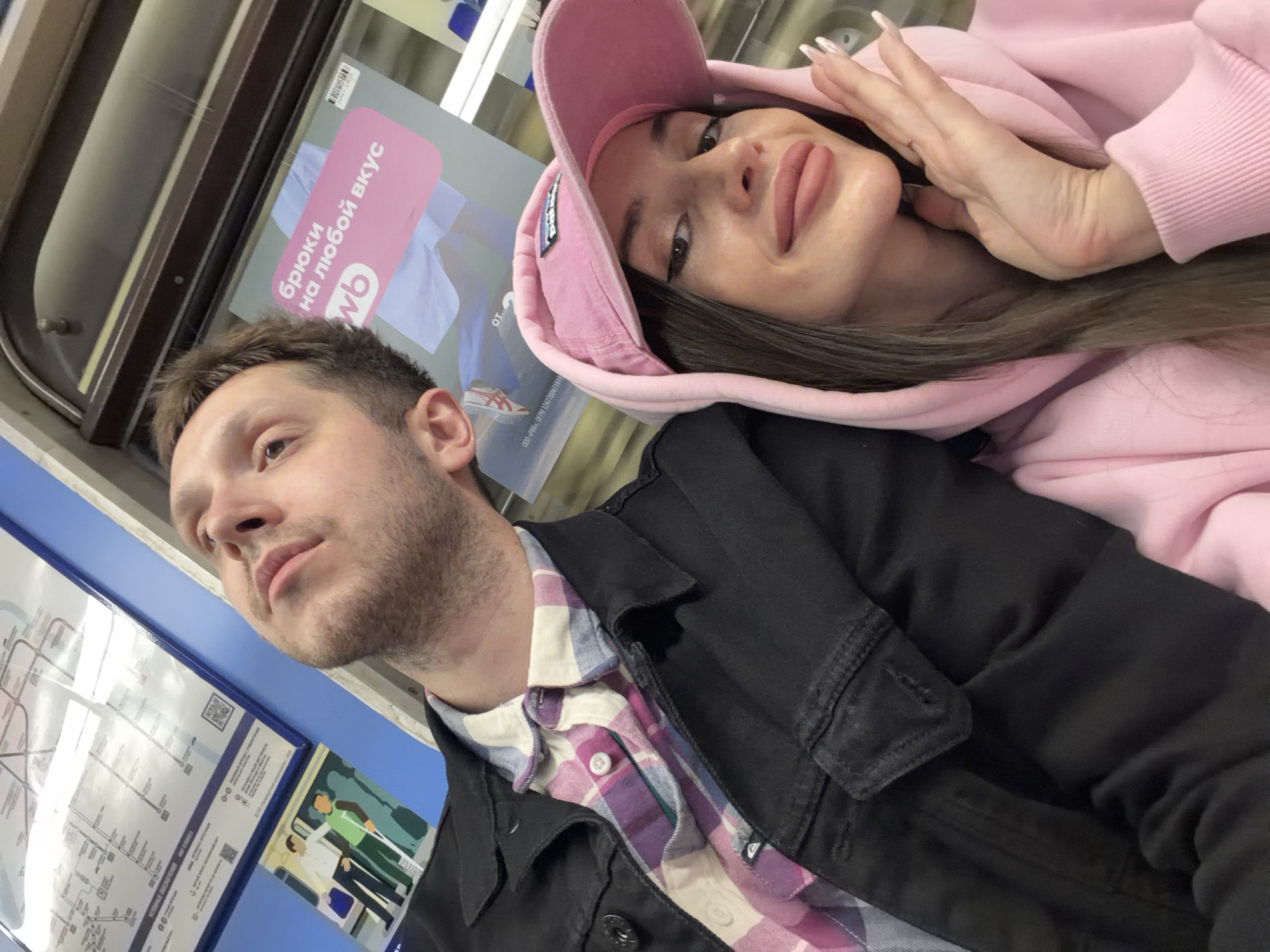 Couple photographs moments together in Saint Petersburg Metro system