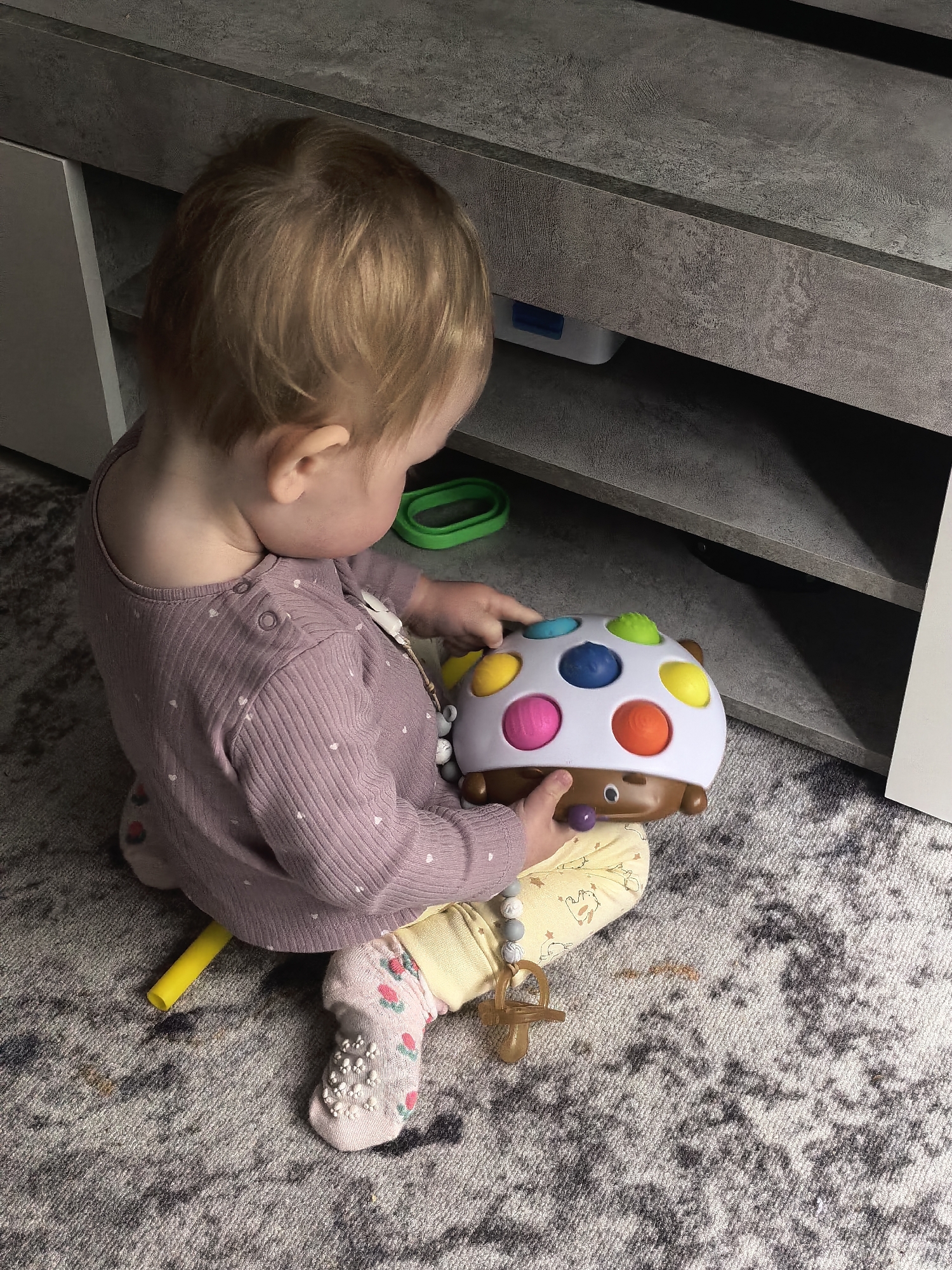 Toddler plays on foam mats in Sterlitamak home