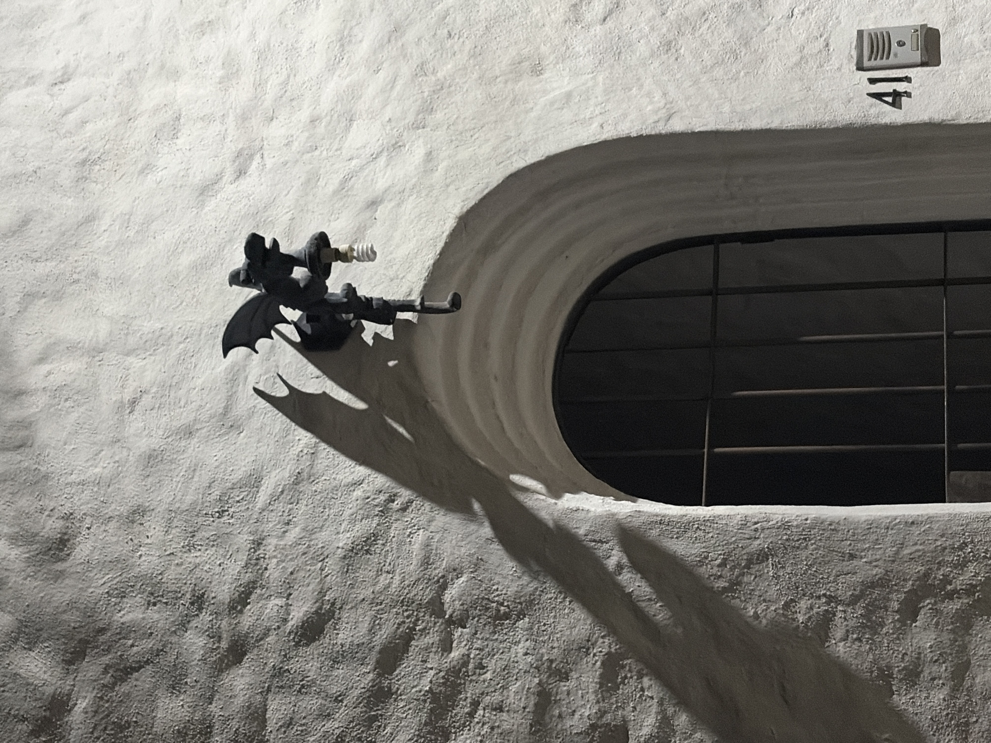 Bat-shaped lamp fixture spotted on wall in Cuernavaca