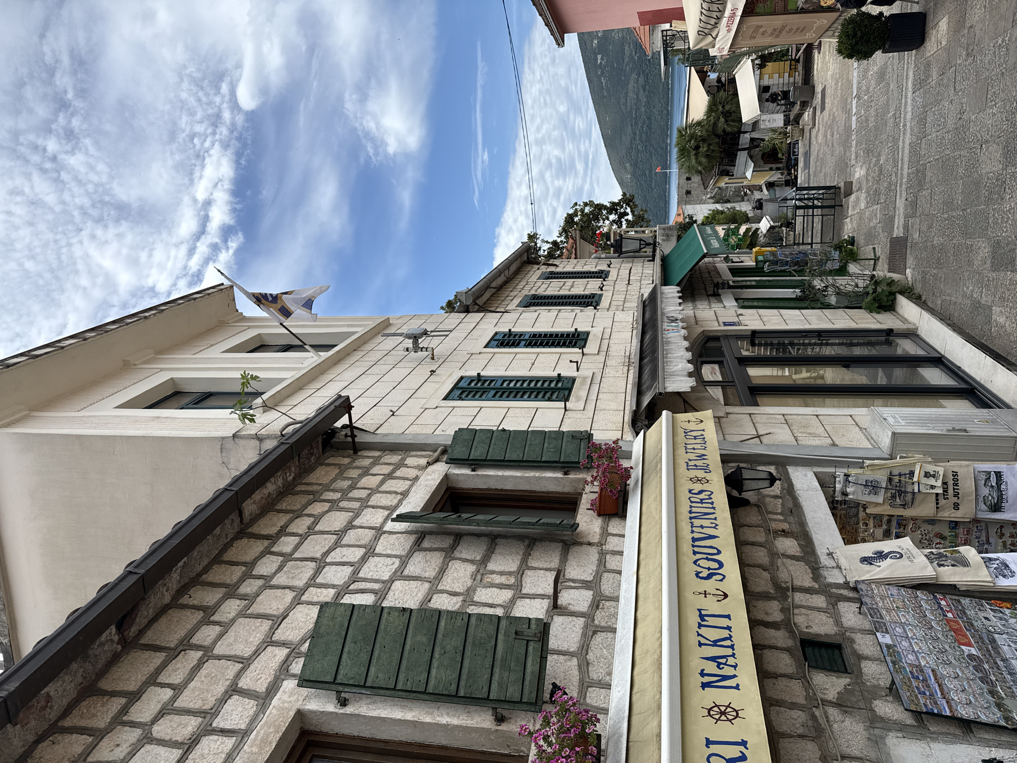 Tourist documents morning walk through historic Herceg Novi Old Town