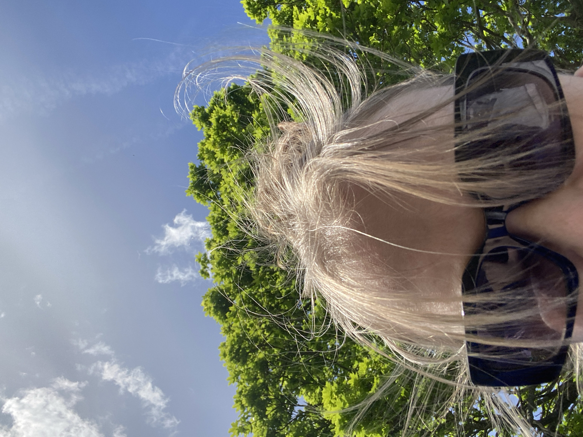 Person photographed in London park on sunny afternoon