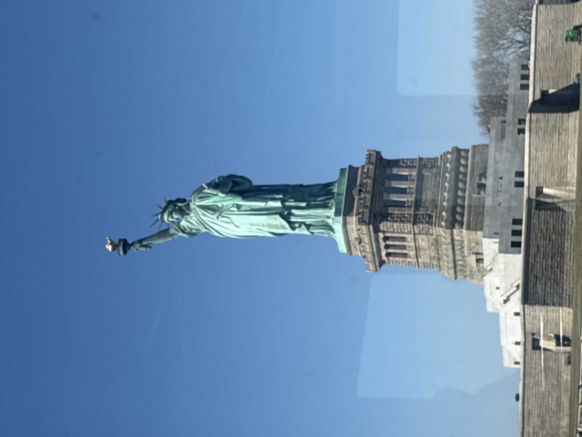 Statue of Liberty photographed from side angle in NYC harbor