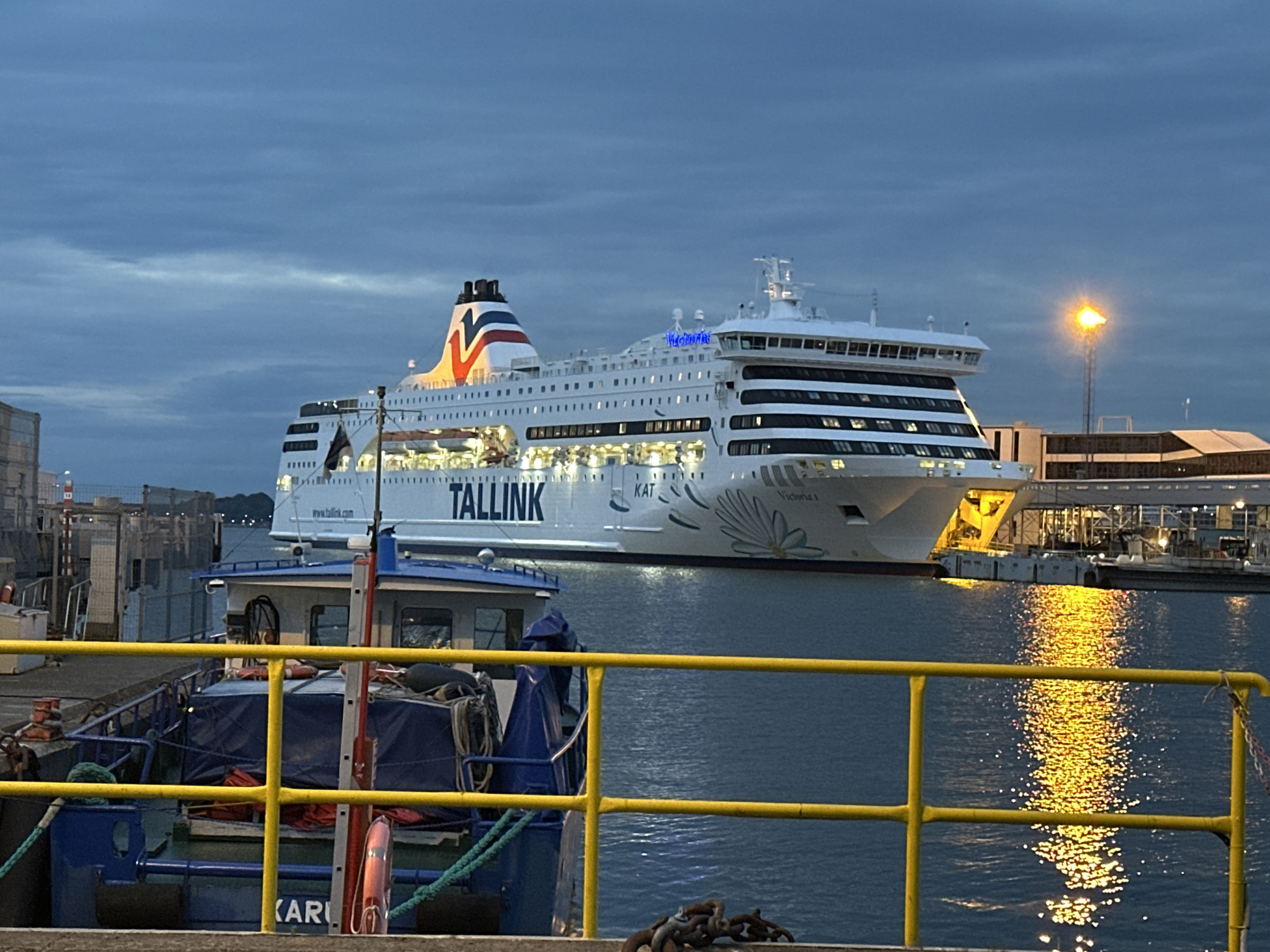 Tallinn harbour at dusk, ferries docked and terminal lights on