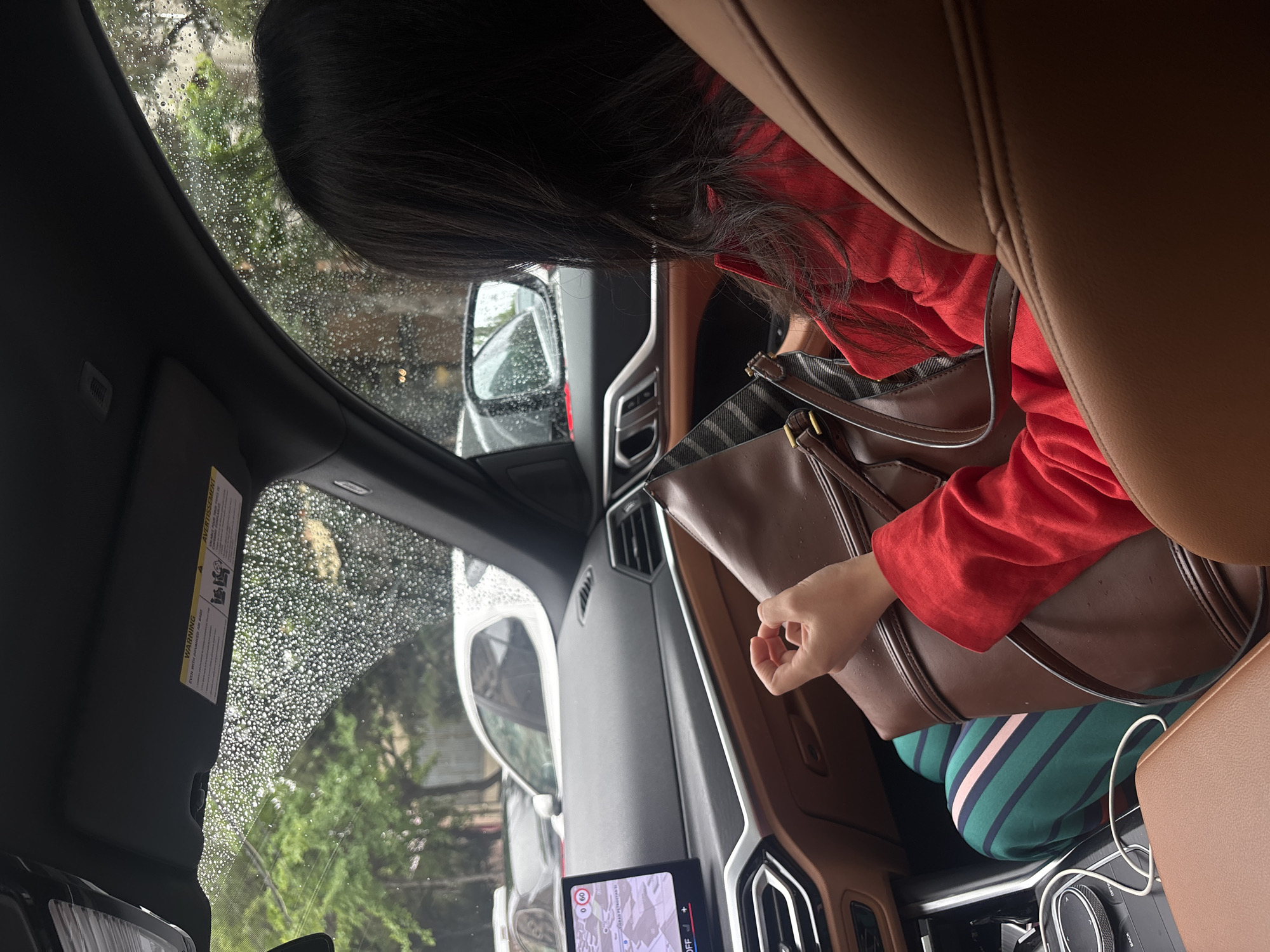 Woman in red observed near vehicle during rainy day in Yerevan