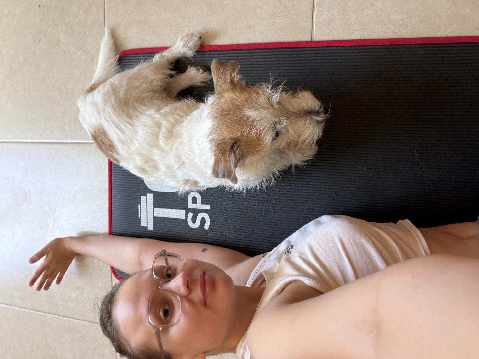 Woman exercises with small dog at Tel-Aviv home