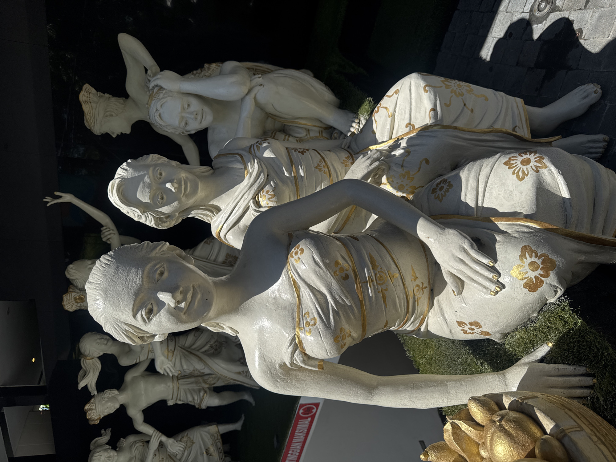 Traditional white and gold statues observed at Kuta hotel