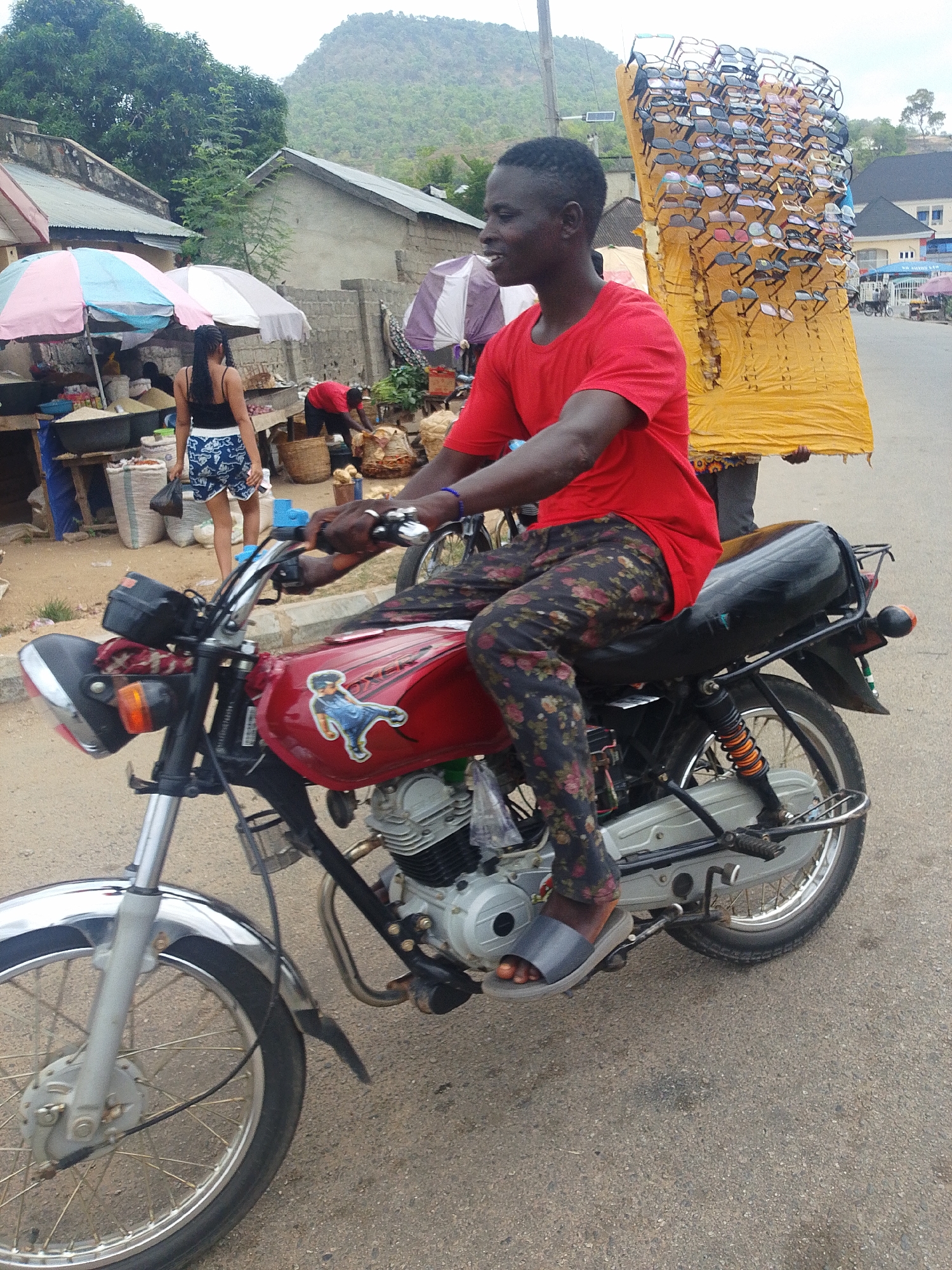 Motorcycle rider and pedestrian share urban street scene