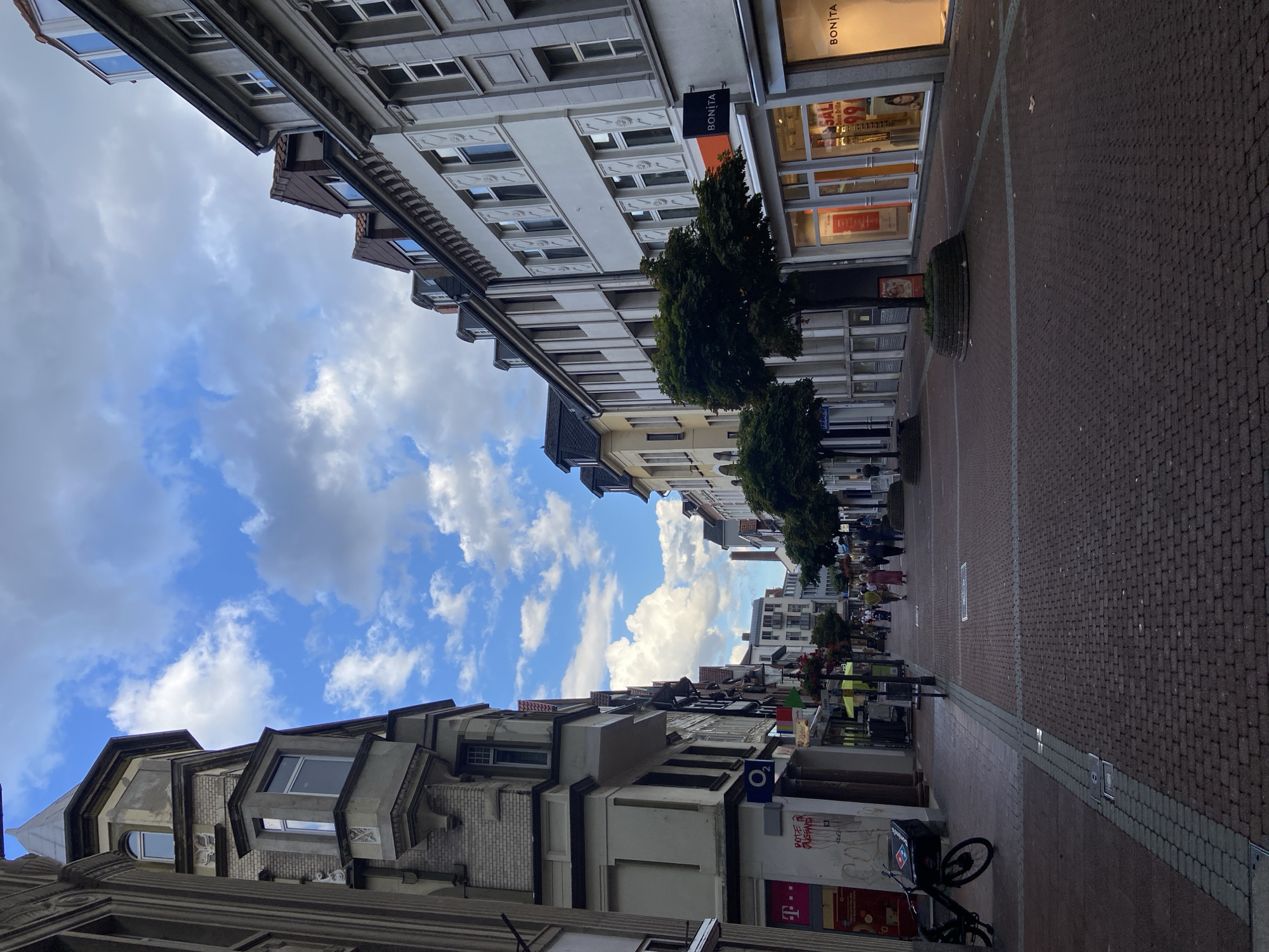 Strolling a European pedestrian district: brick streets, old stonework, church tower