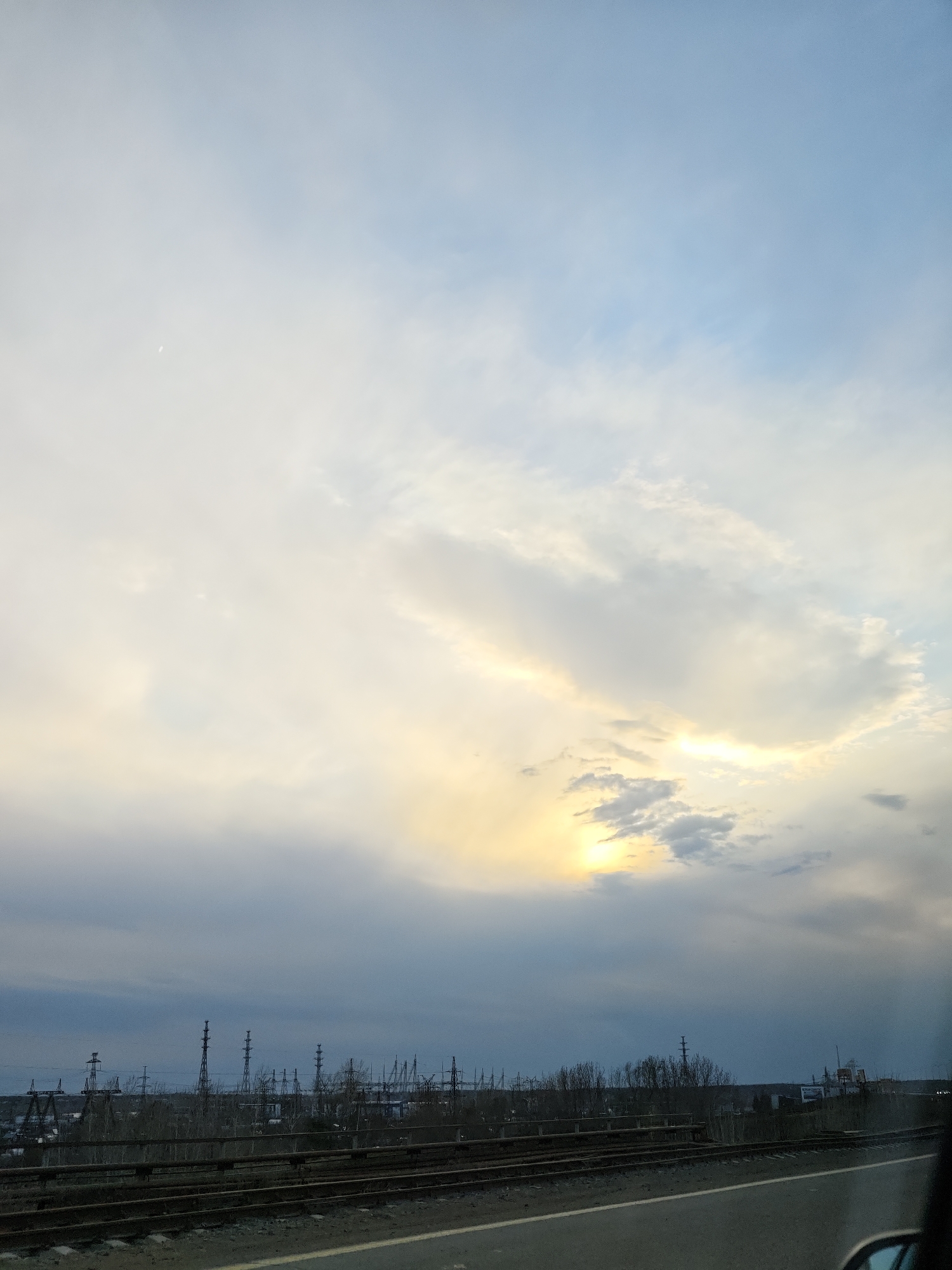 Industrial landscape and waterway observed from moving vehicle in Chaikovsky