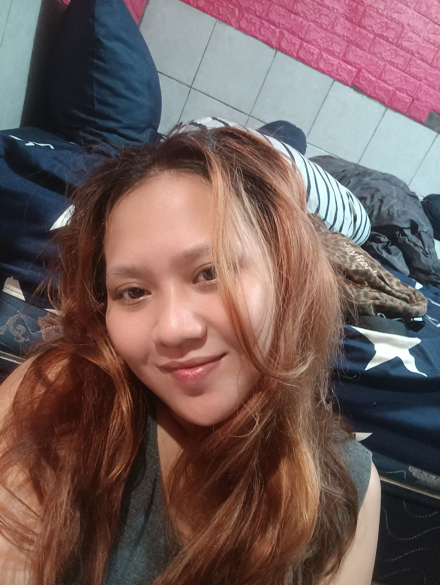 Woman documents selfie session in Depok bedroom