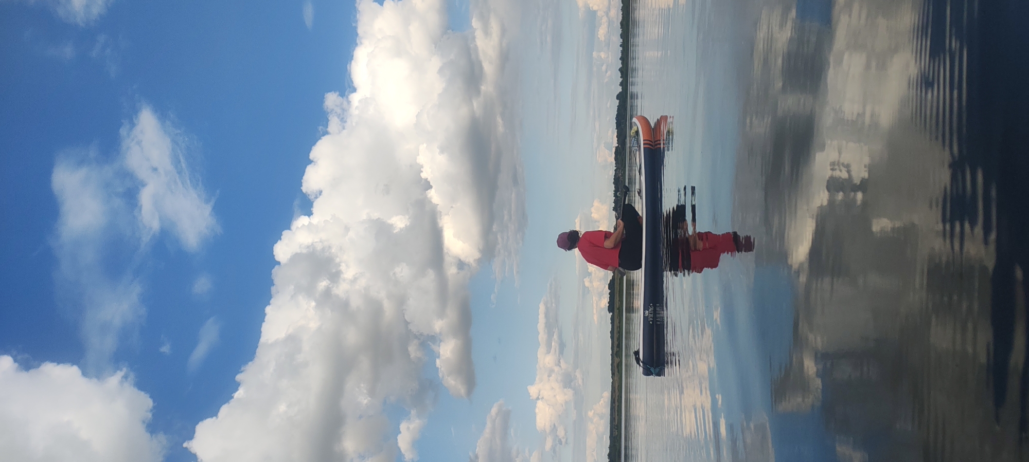 Cross-legged on a paddleboard, drifting on calm Russian waters