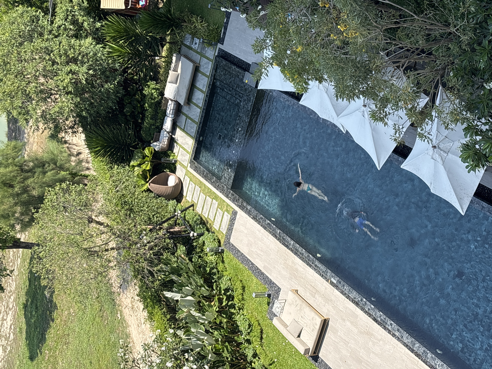 Two swimmers enjoy morning pool time in Choeng Thale