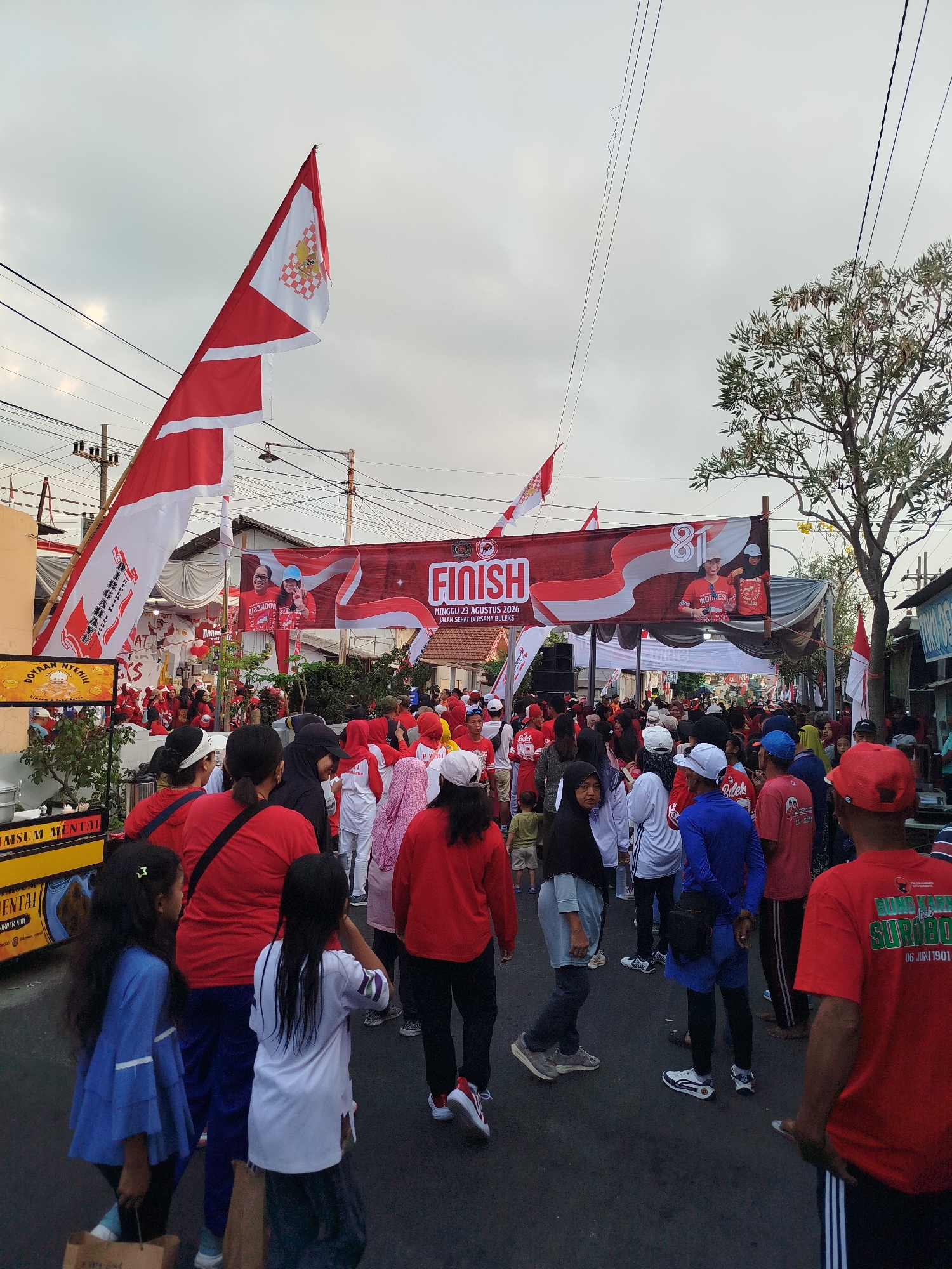 Crowds gather at a race finish line in Surabaya