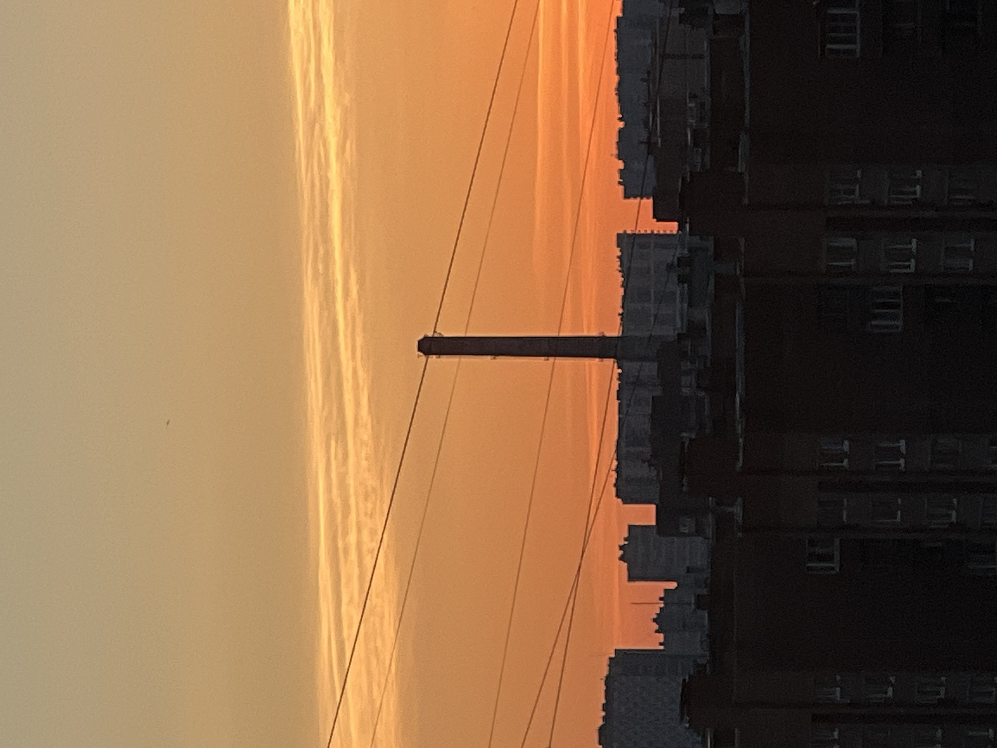 Sinyavino at golden hour: apartment blocks, chimneys, and trams