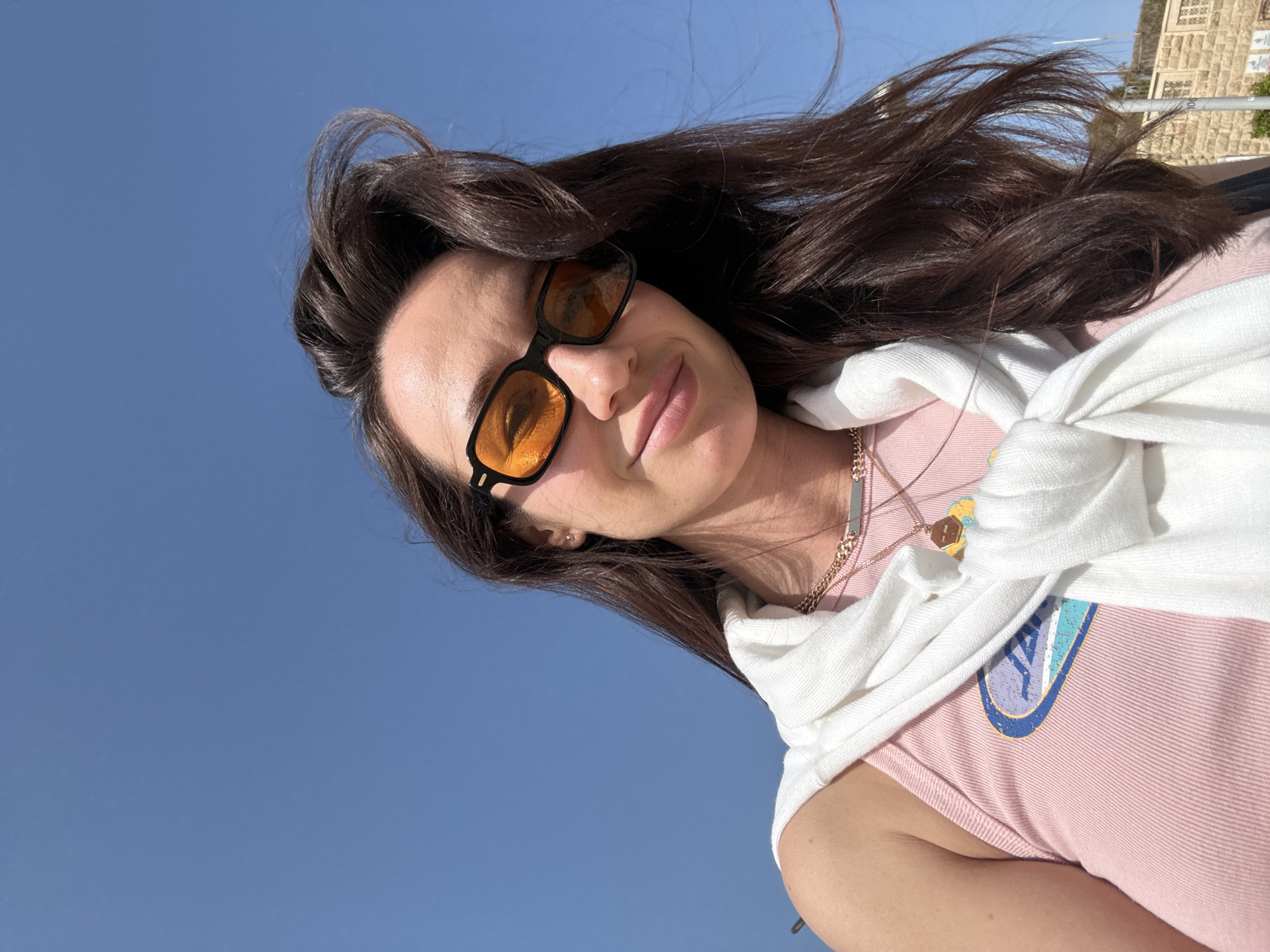 Woman takes selfie on busy Tel Aviv beach afternoon