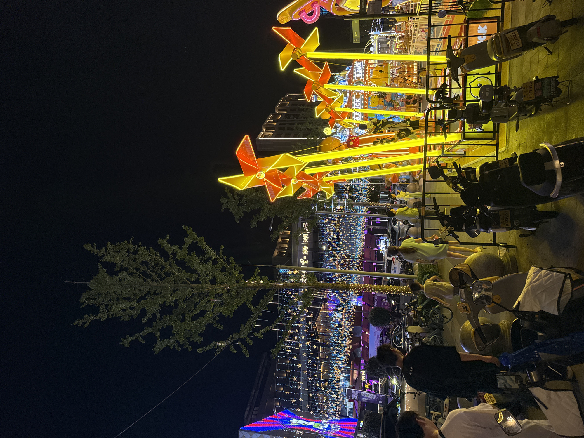 Neon-lit carnival rides and street fun in Yiwu at night