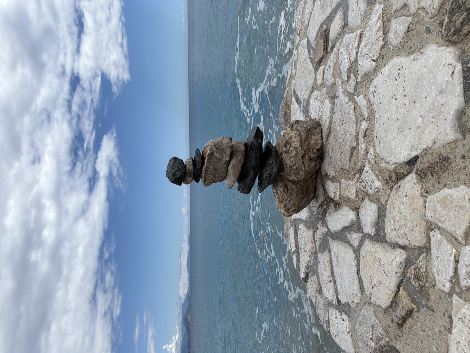 Rock cairn spotted on Montenegro coast under sunny skies