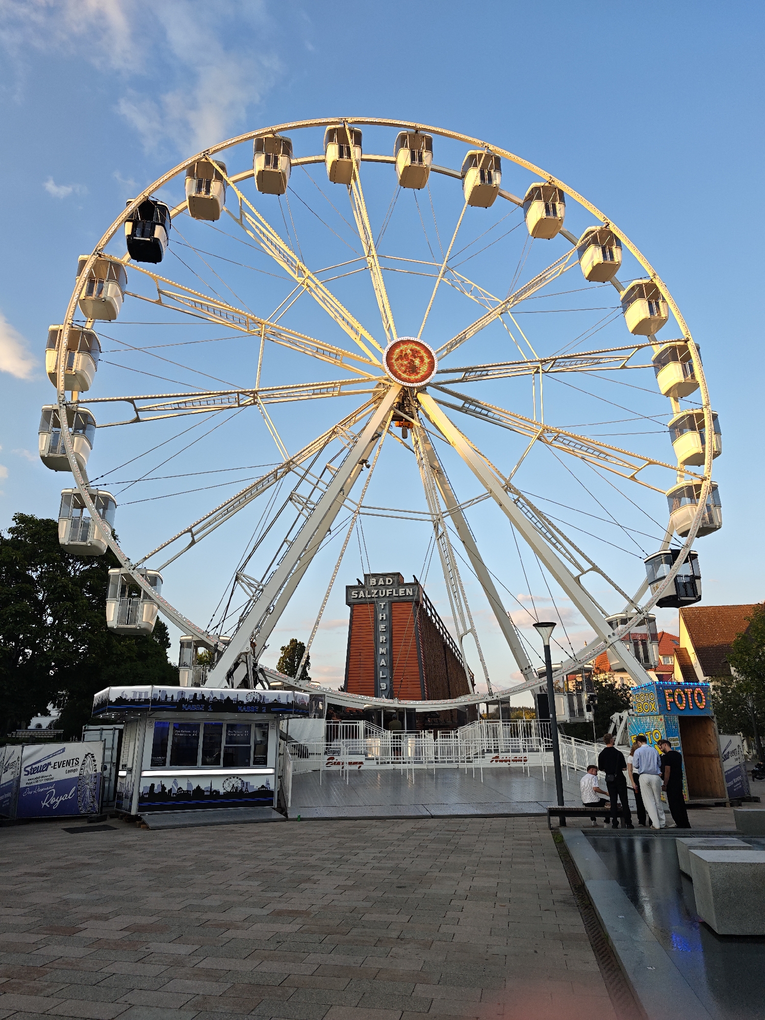 Ferris wheel glows at dusk over Bad Salzuflen's town center