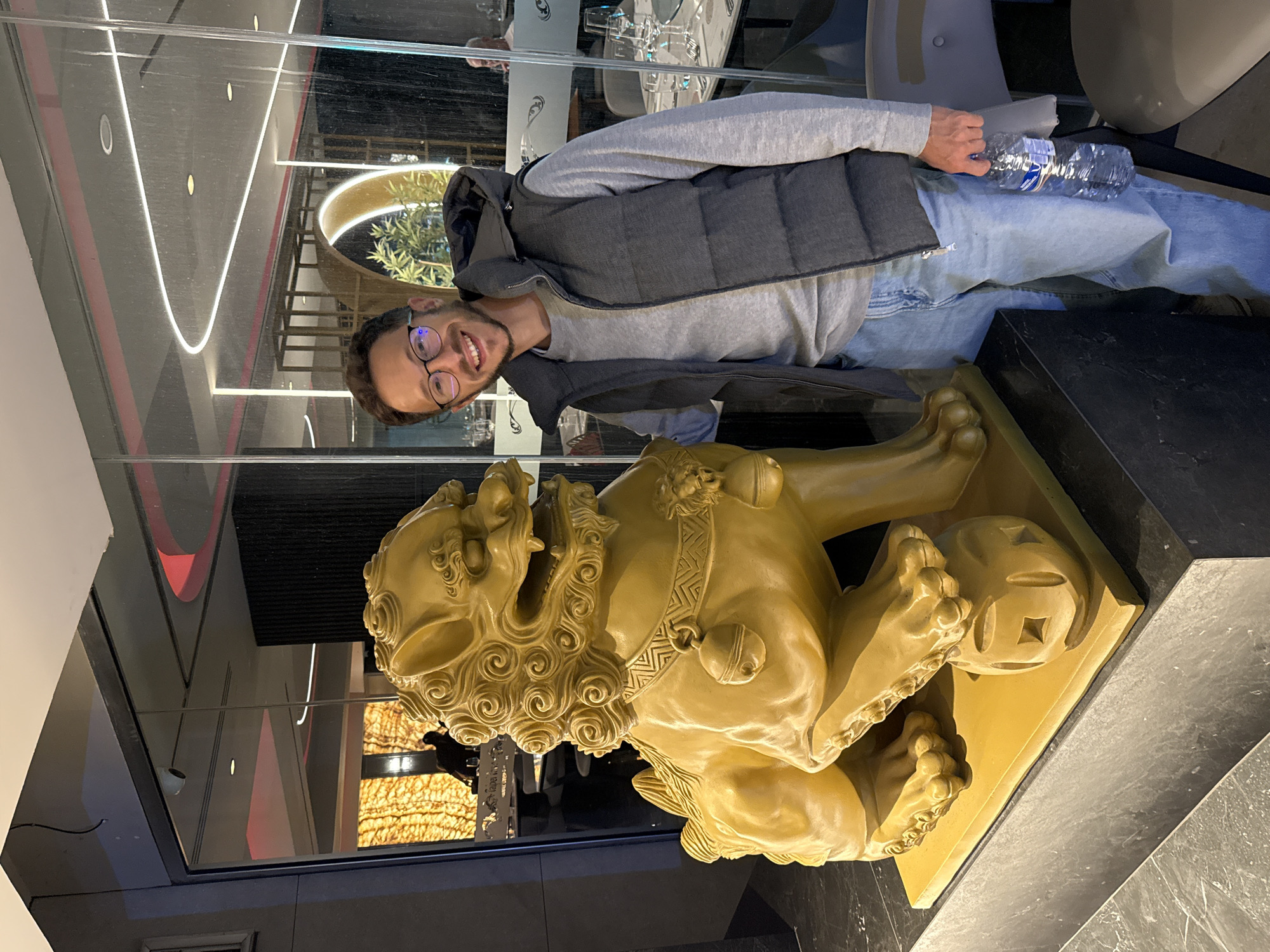 Man photographed with golden lion statue in Larnaca