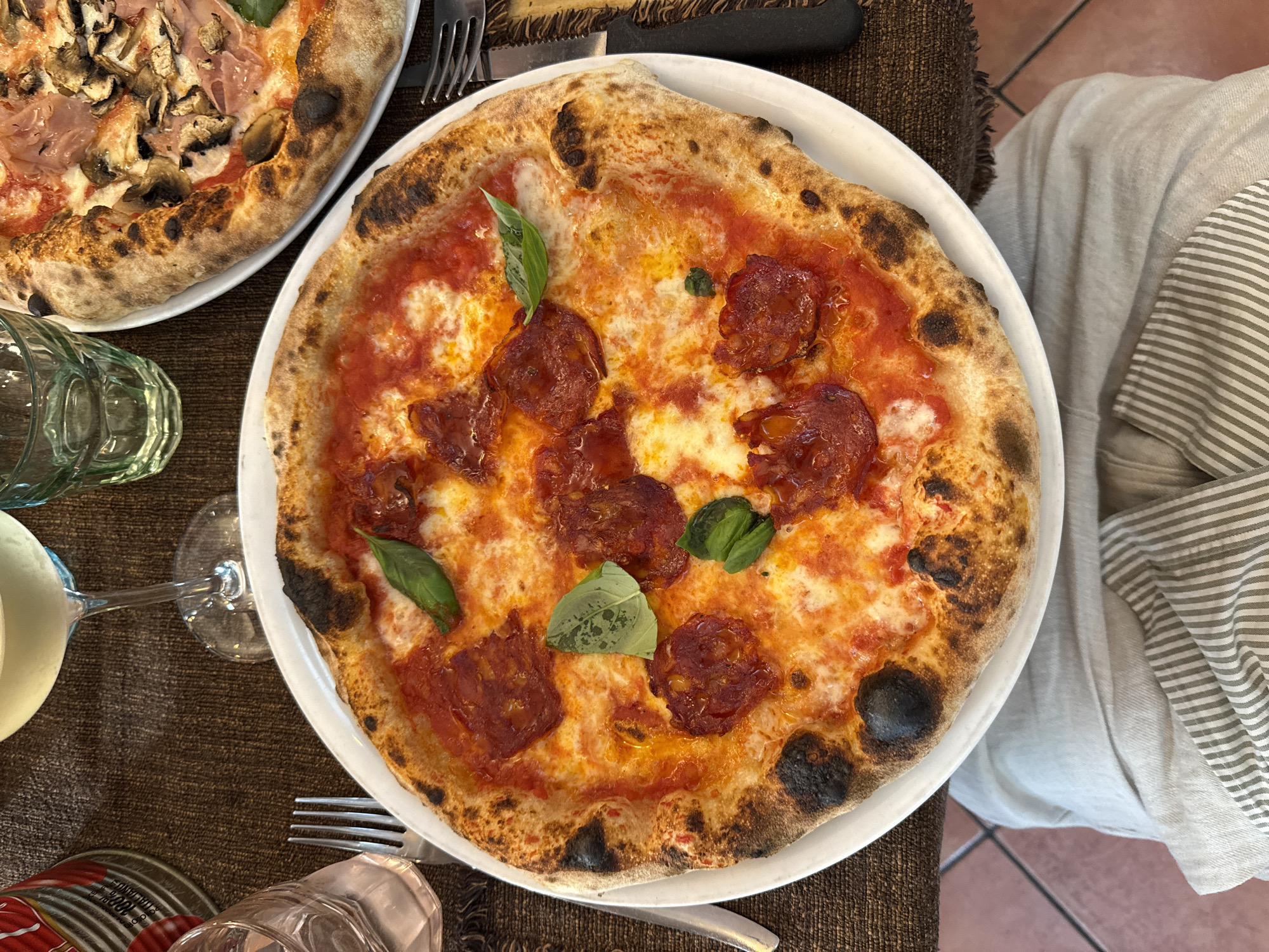 Artisan pizzas on a Milan restaurant table, top-down view