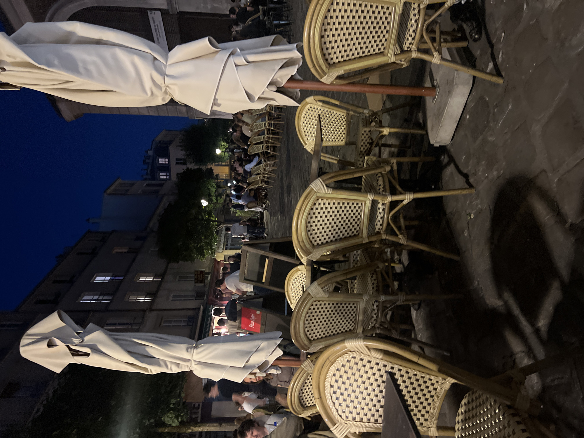 Versailles café terrace winding down at dusk