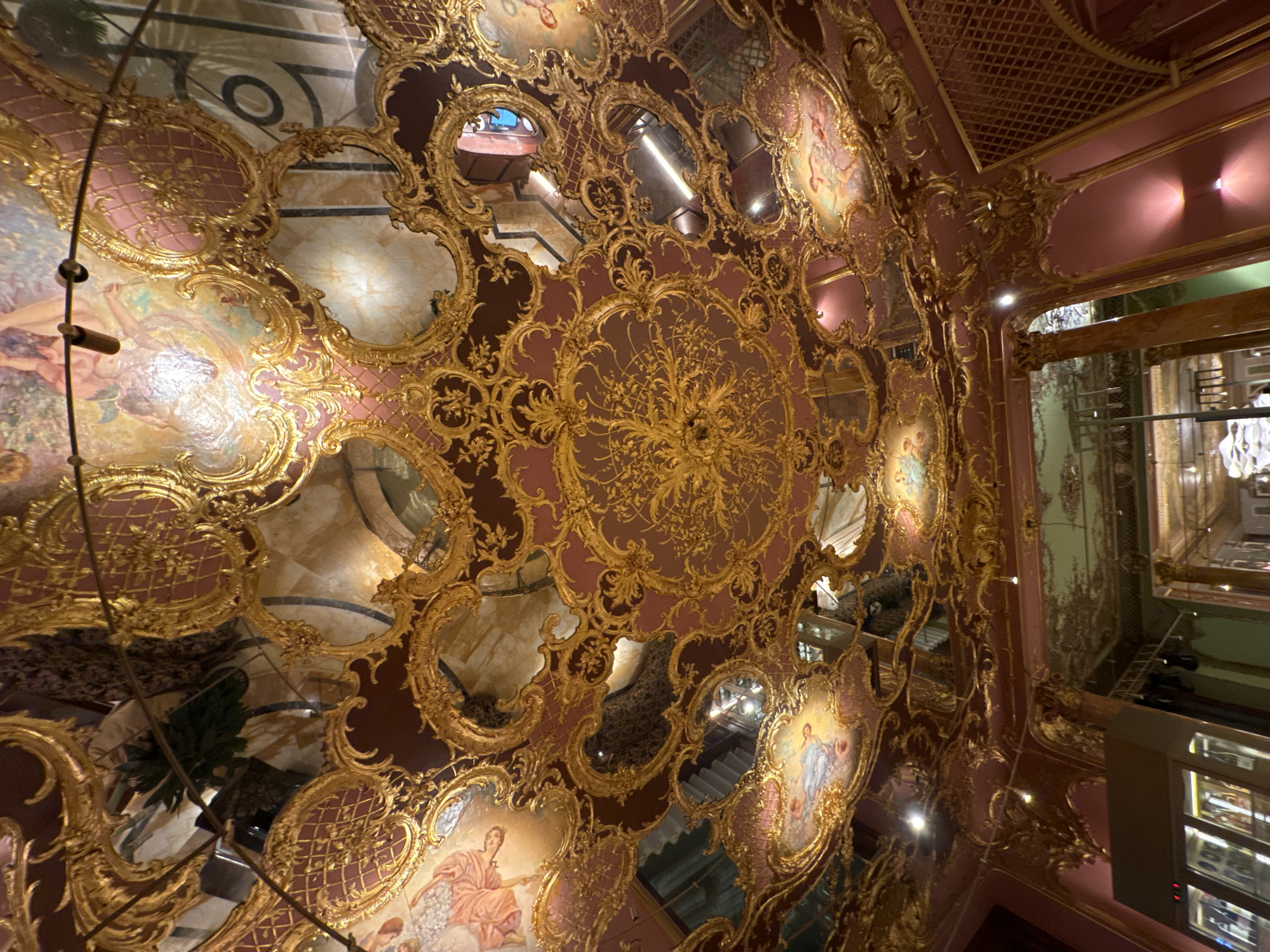 Ornate Moscow interior with gold ceiling and fountain documented