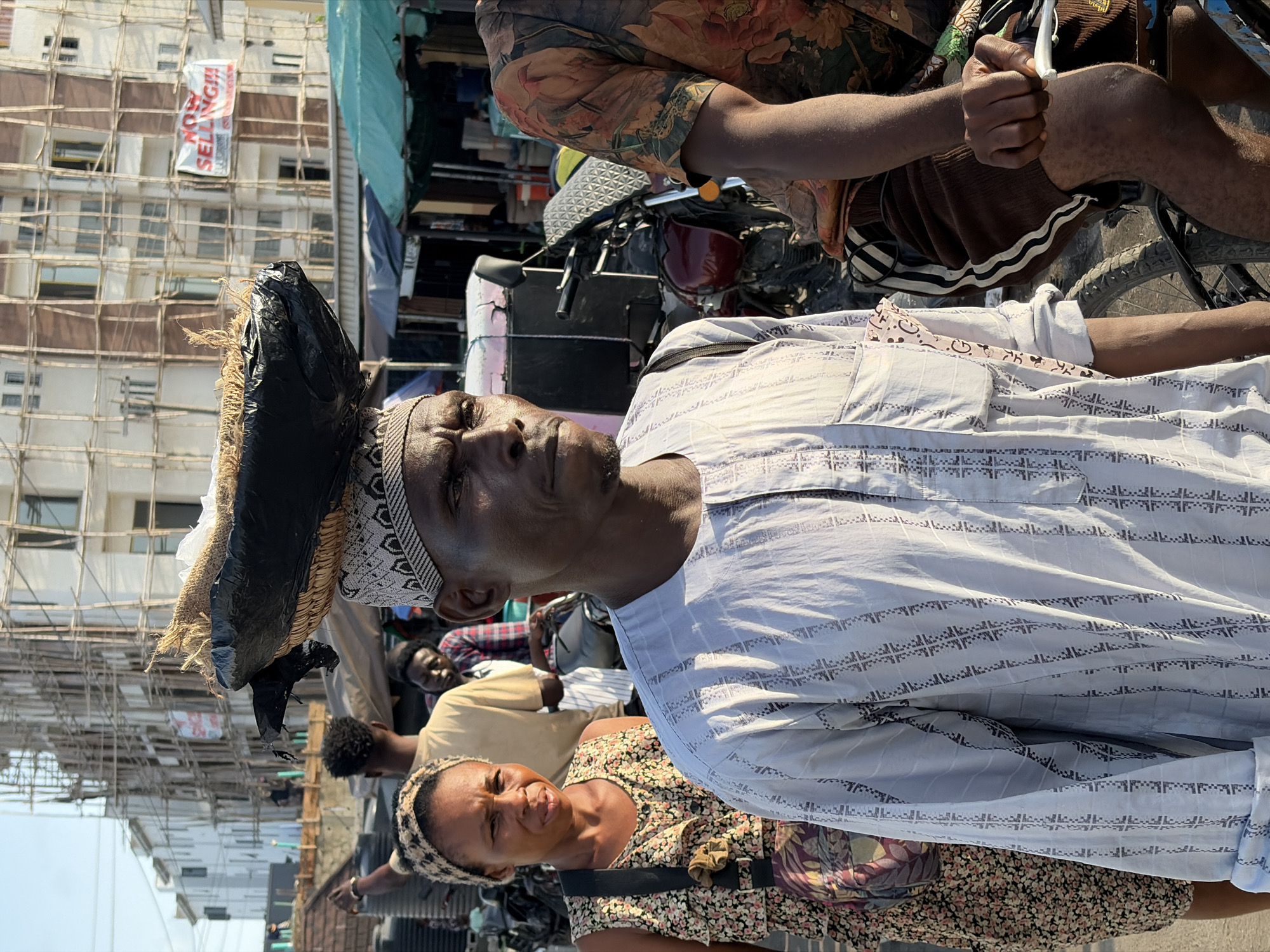 Daily life scenes documented in Igboefon, Nigeria include damaged vehicle