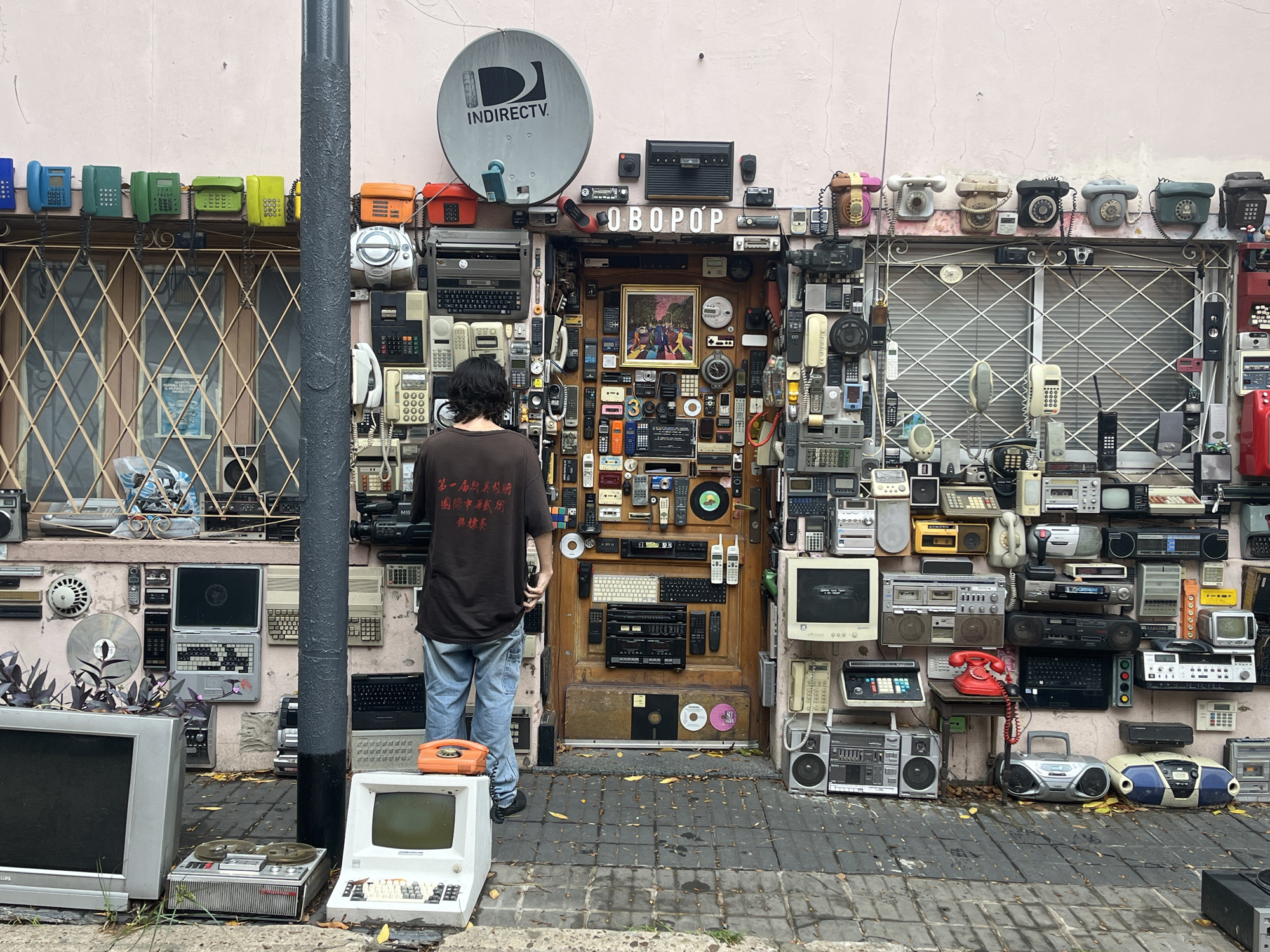 Woman poses with vintage electronics in Buenos Aires street art
