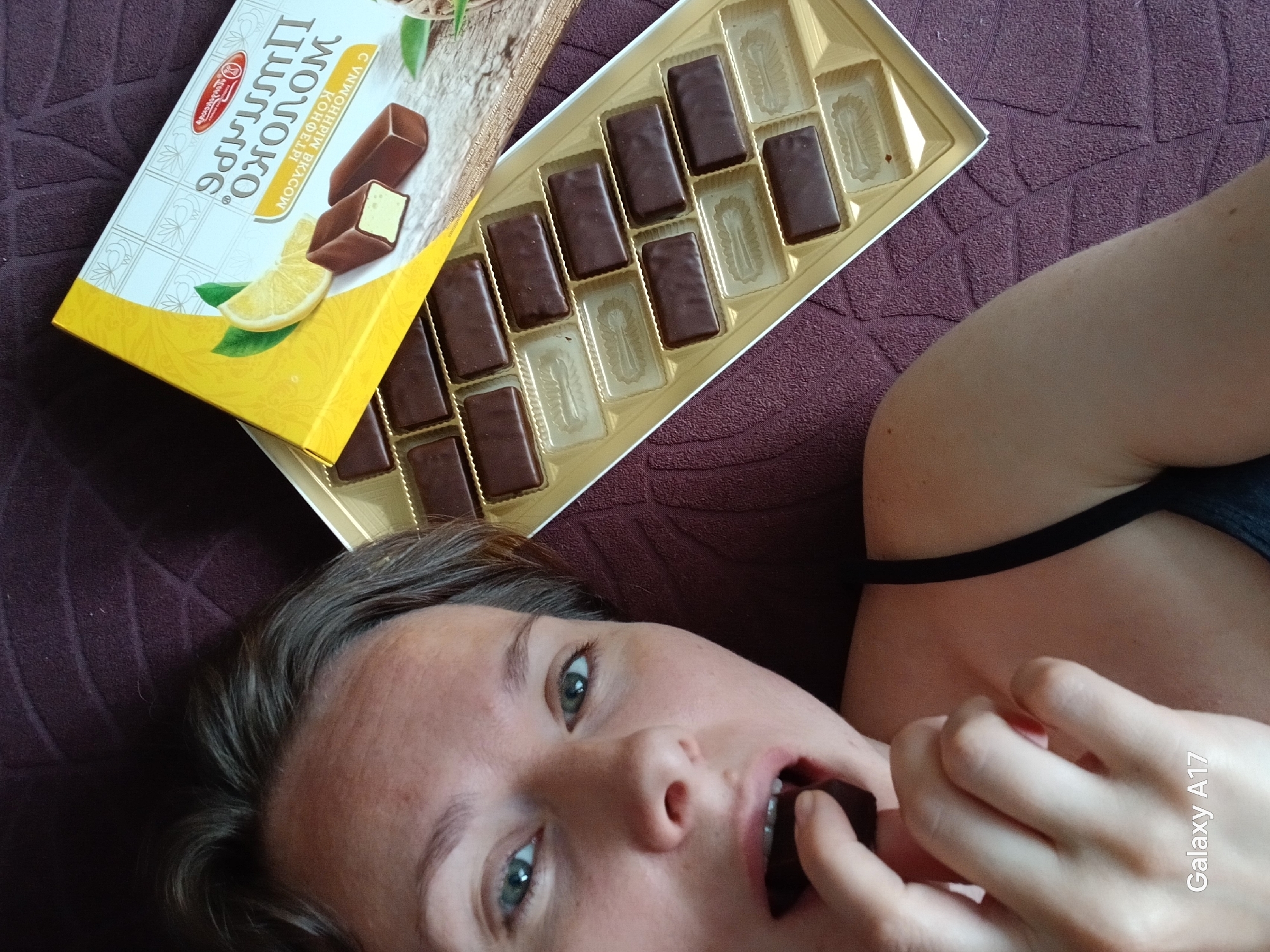 Woman enjoys Russian chocolates during morning treat in Yekaterinburg