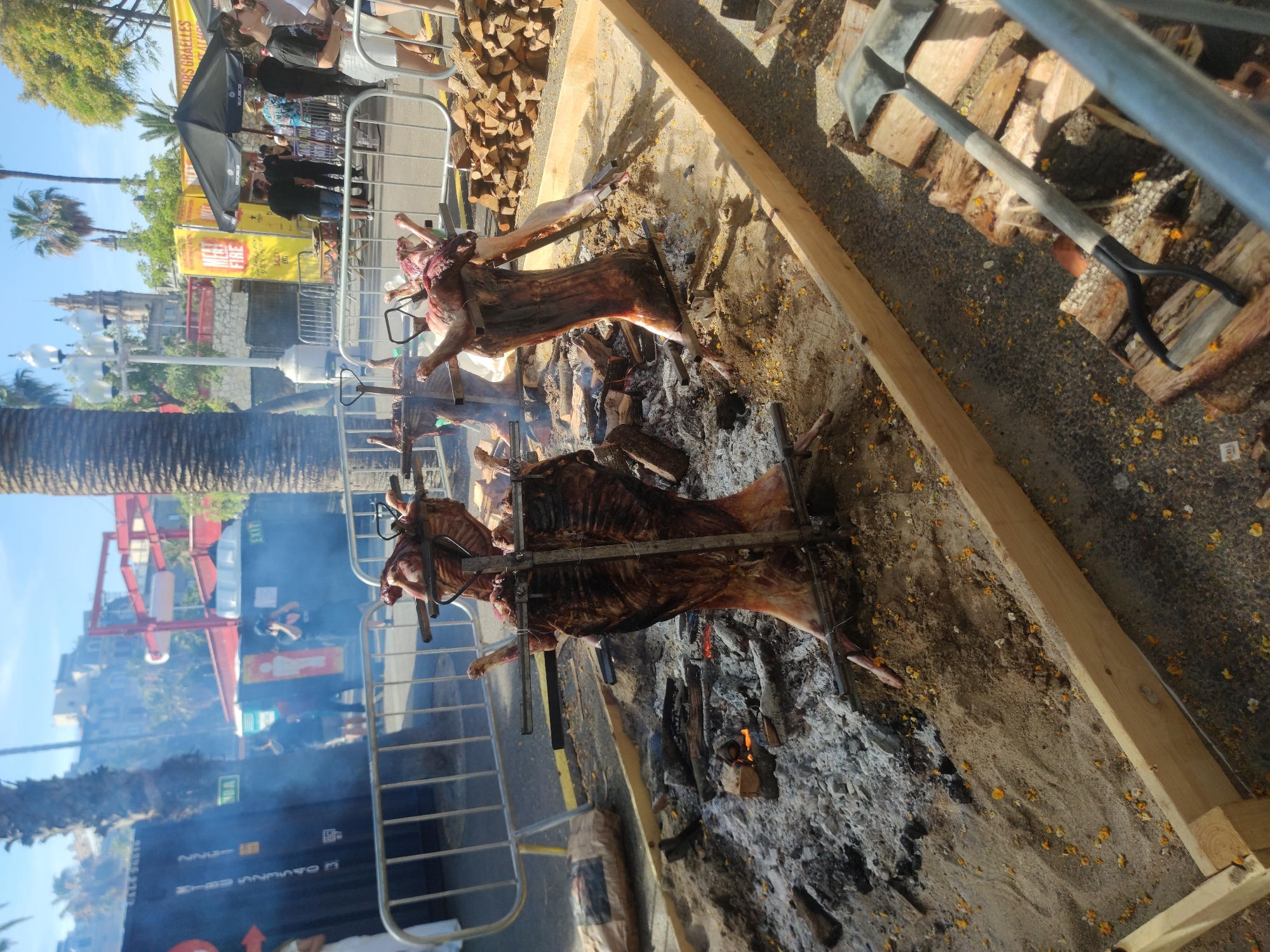 Outdoor festival with roasted pigs and marina views in Barcelona