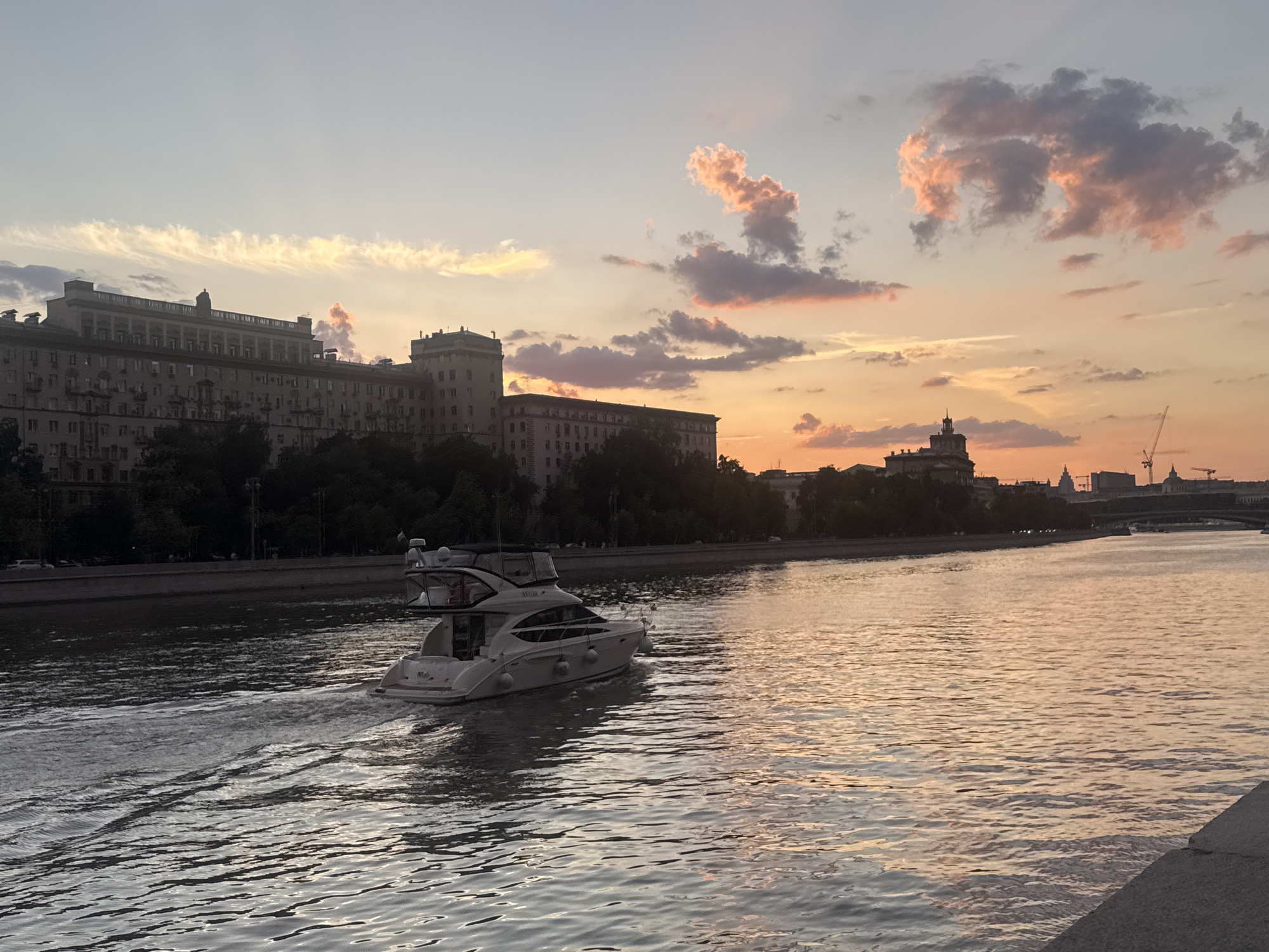 Sunset over the Moskva River, cyclists and skyline in frame