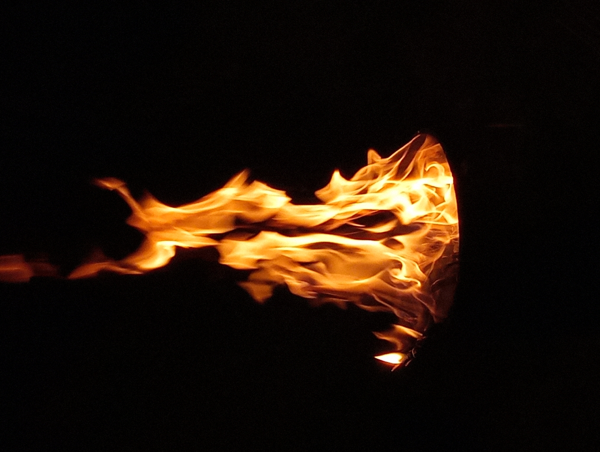 Metal barrel fire burning at night in Shymkent