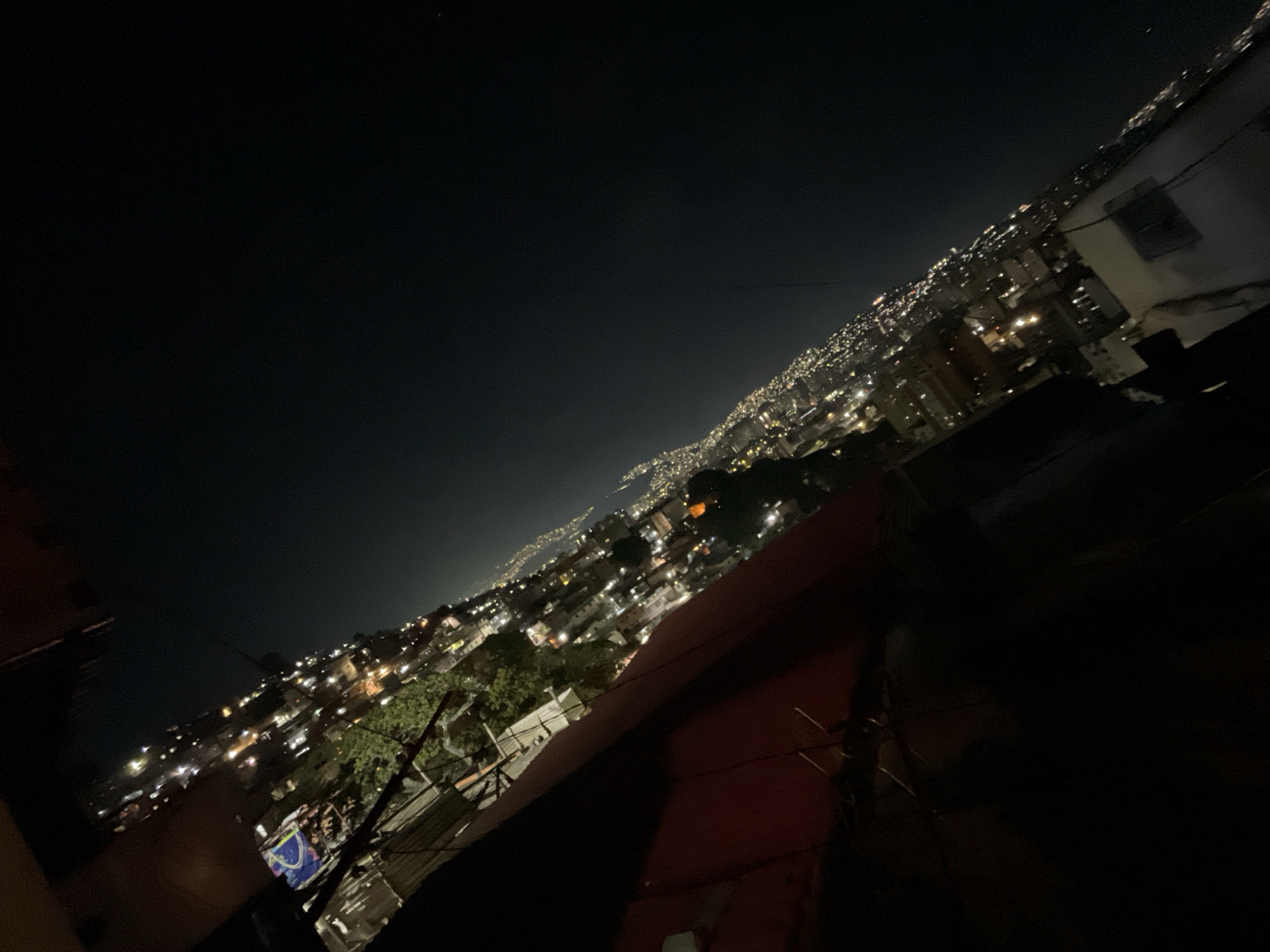 Night photography captures Caracas city lights beneath mountains