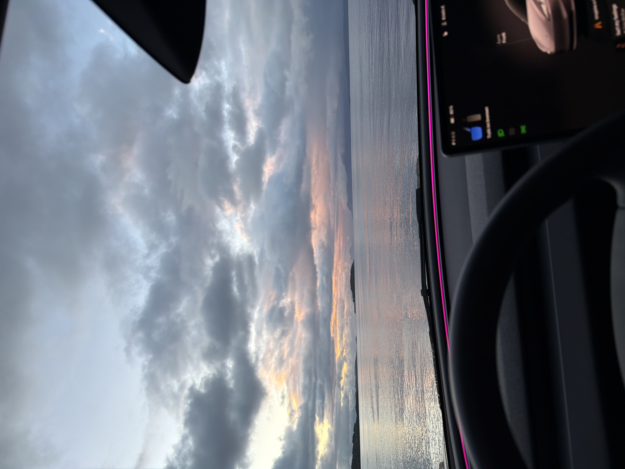 Moody Nordic sunset over Harstad's waterfront, viewed from a car