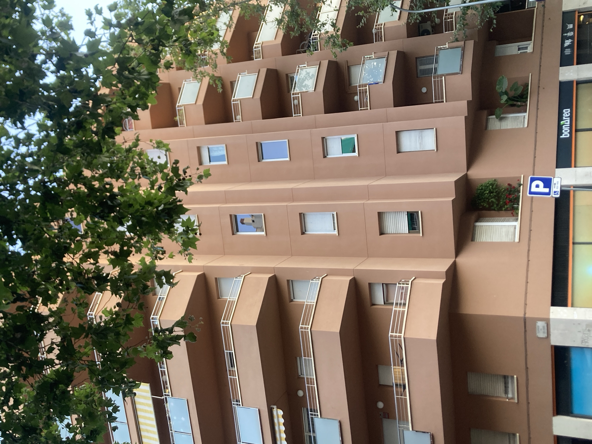 Barcelona apartment blocks and a shuttered cafeteria at street level