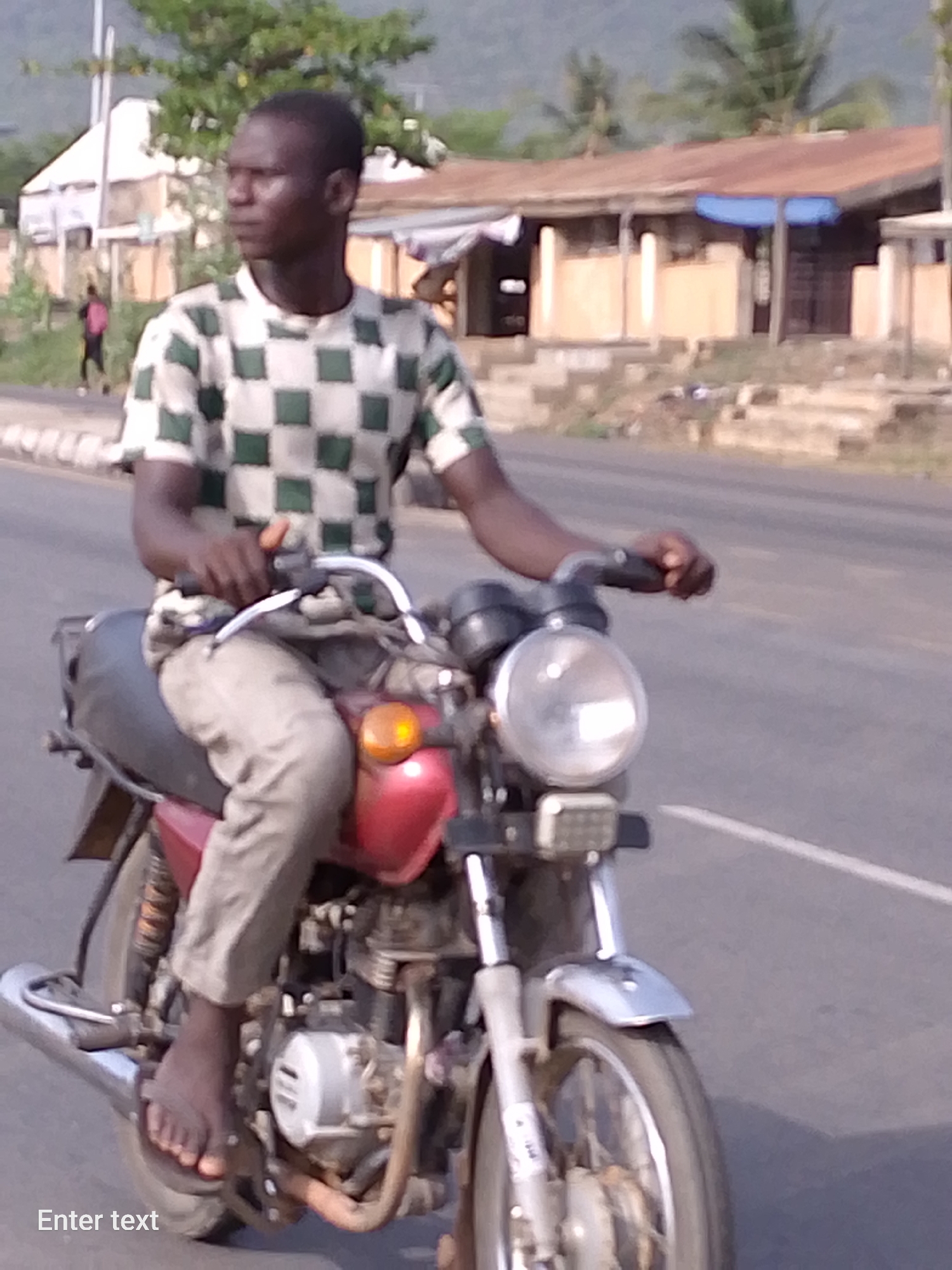 Routine street traffic documented in Adankolo, Nigeria Sunday afternoon