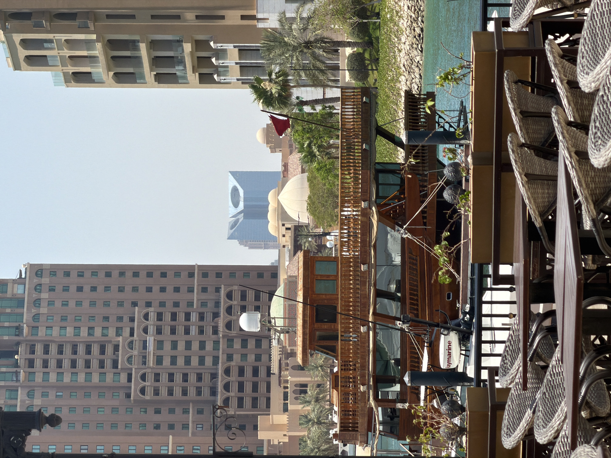 Urban waterfront district with boats, fountains captured by witnesses
