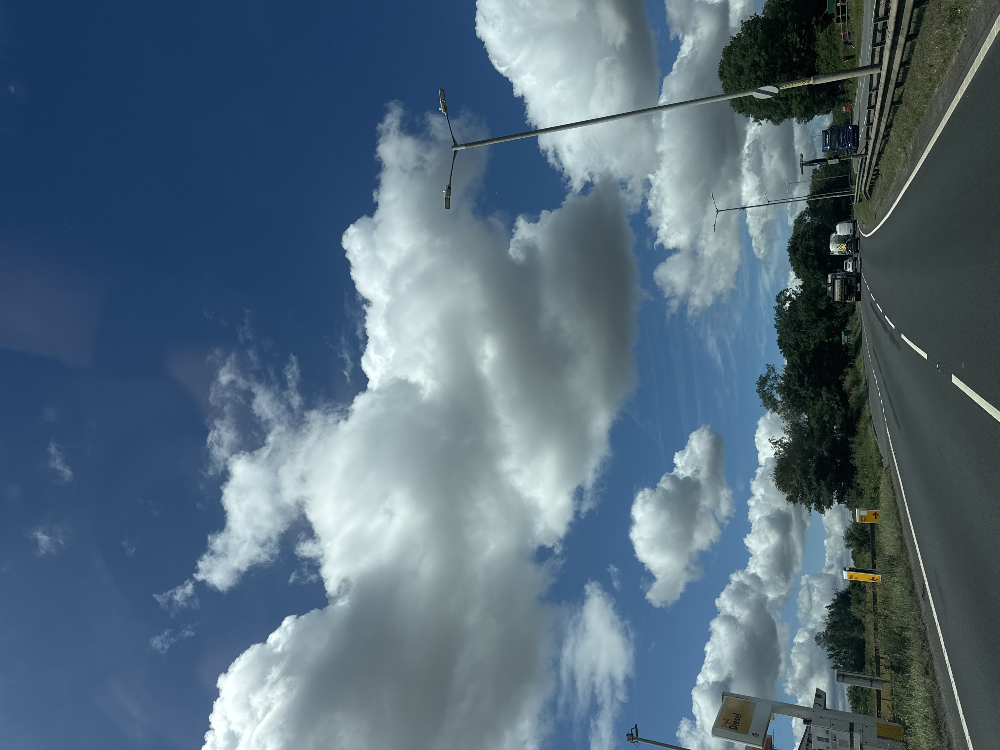 Trucks rolling down an open highway under a blue sky