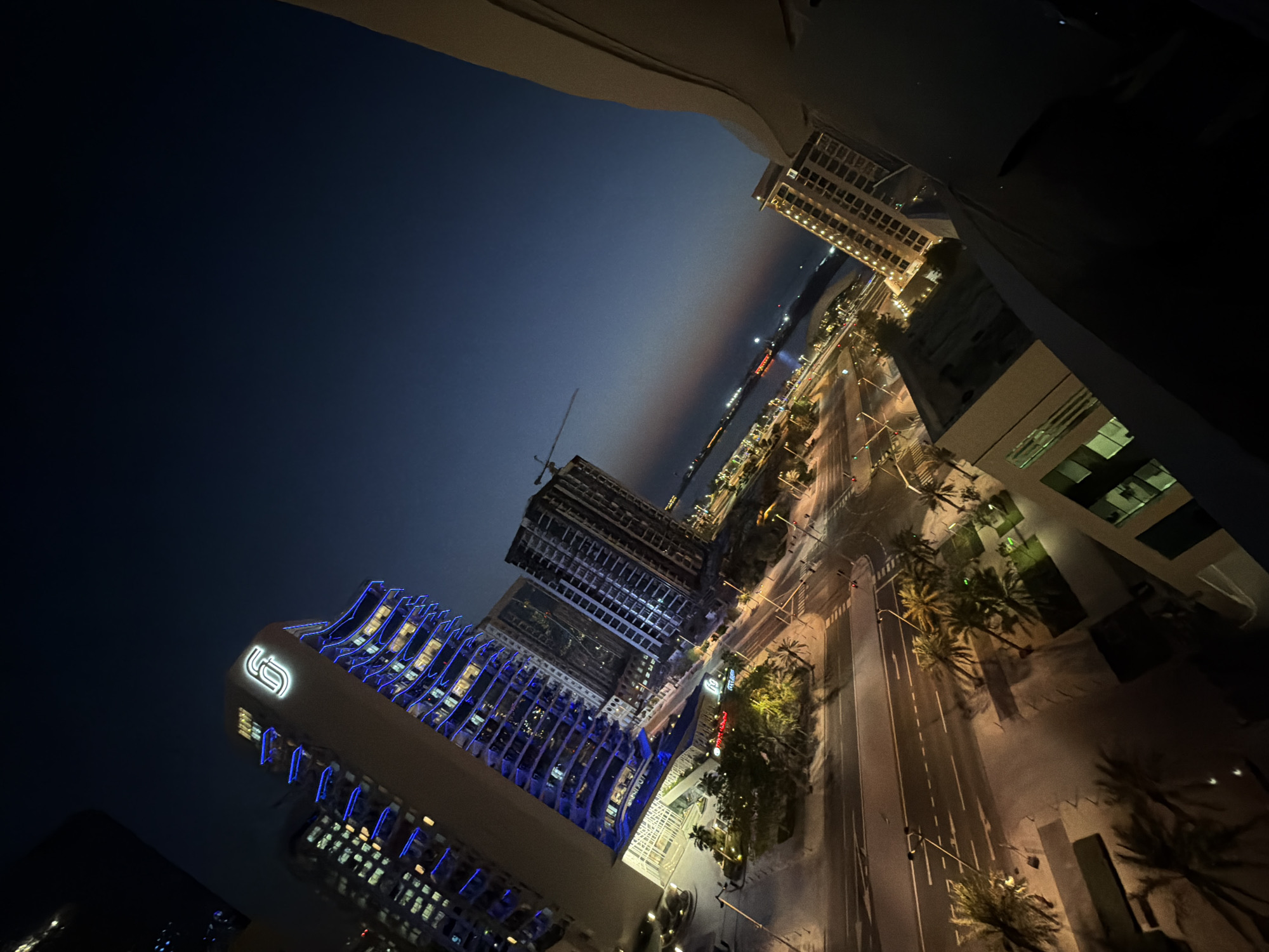 Lusail skyline glows at dusk along the harbor